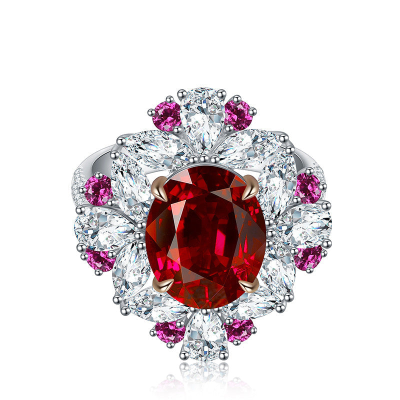 Luxurious ruby engagement ring crafted from 925 sterling silver, featuring a simulated red ruby center stone surrounded by white sapphires and pink accents.