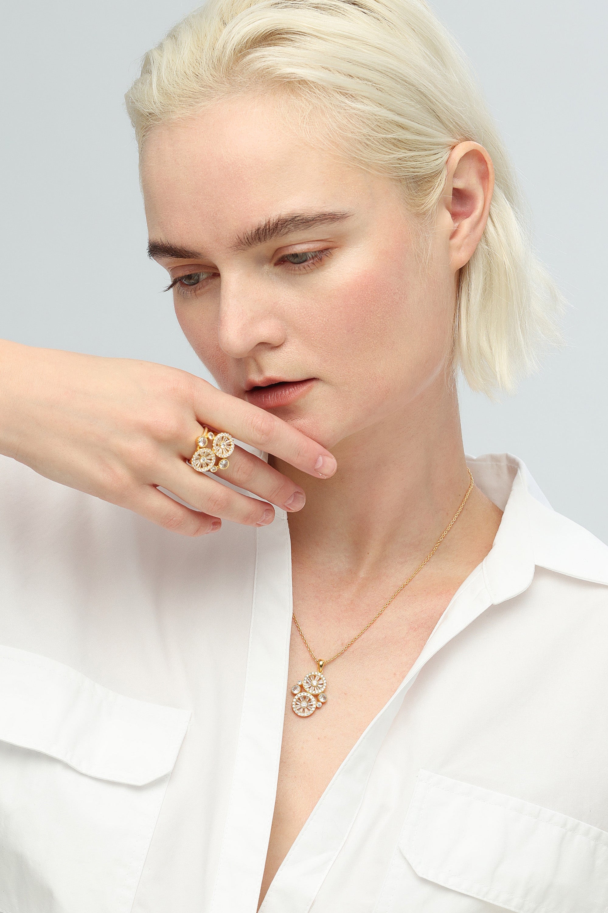 A stunning Wheel of Fortune Necklace featuring a unique wheel design adorned with sparkling pavé-set cubic zirconia, elegantly displayed on a soft background.