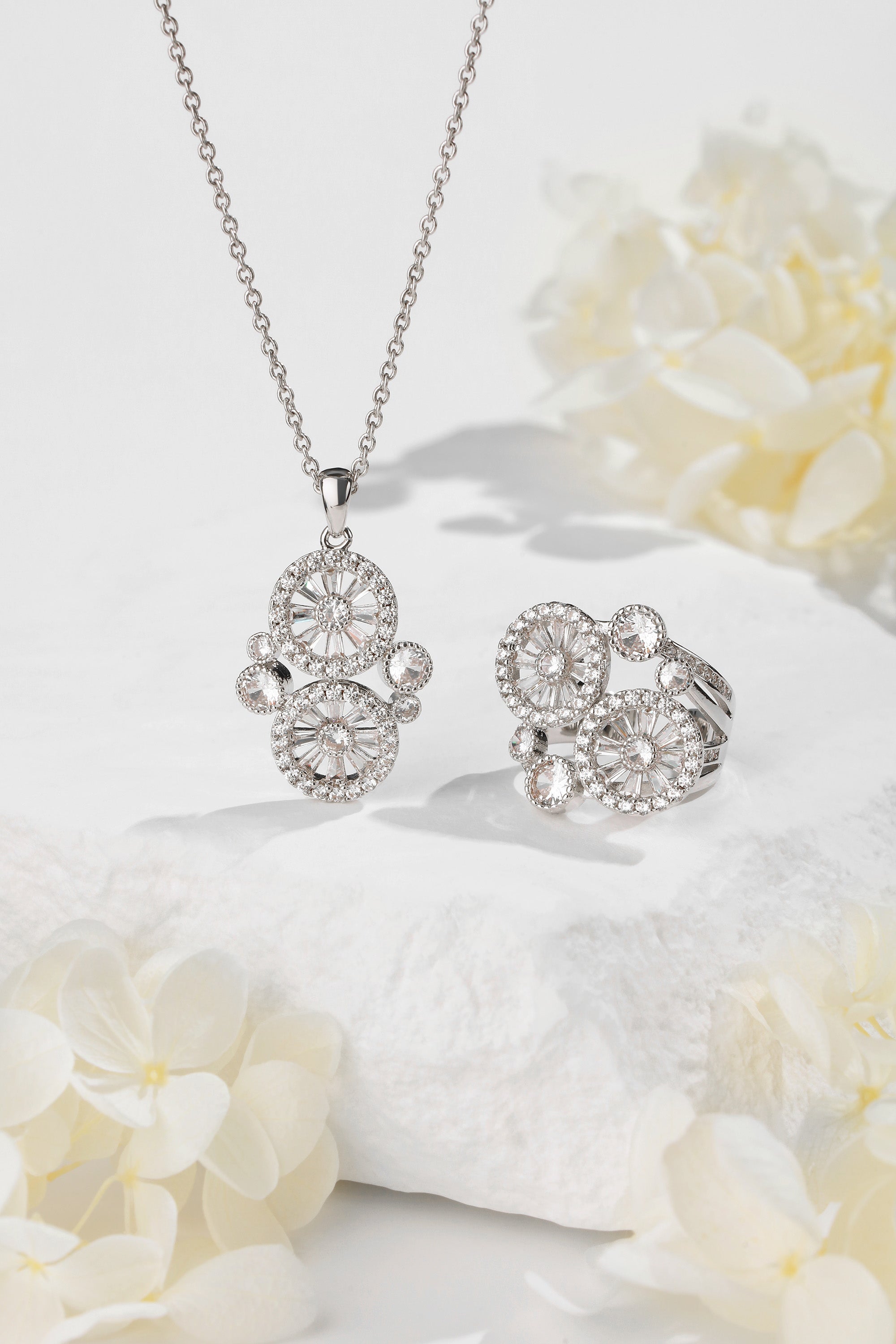 A stunning Wheel of Fortune Necklace featuring a unique wheel design adorned with sparkling pavé-set cubic zirconia, elegantly displayed on a soft background.