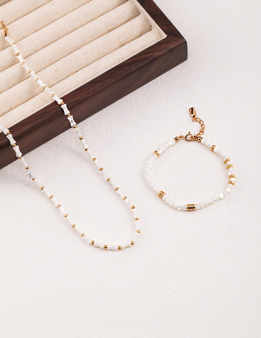 Elegant White Bamboo Choker Necklace made from Horseshoe Snail and Gold Vermeil, showcasing its delicate design and adjustable chain.