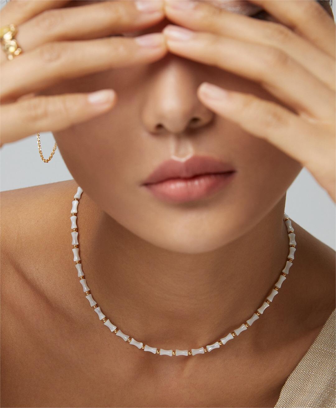 Elegant White Bamboo Choker Necklace made from Horseshoe Snail and Gold Vermeil, showcasing its delicate design and adjustable chain.