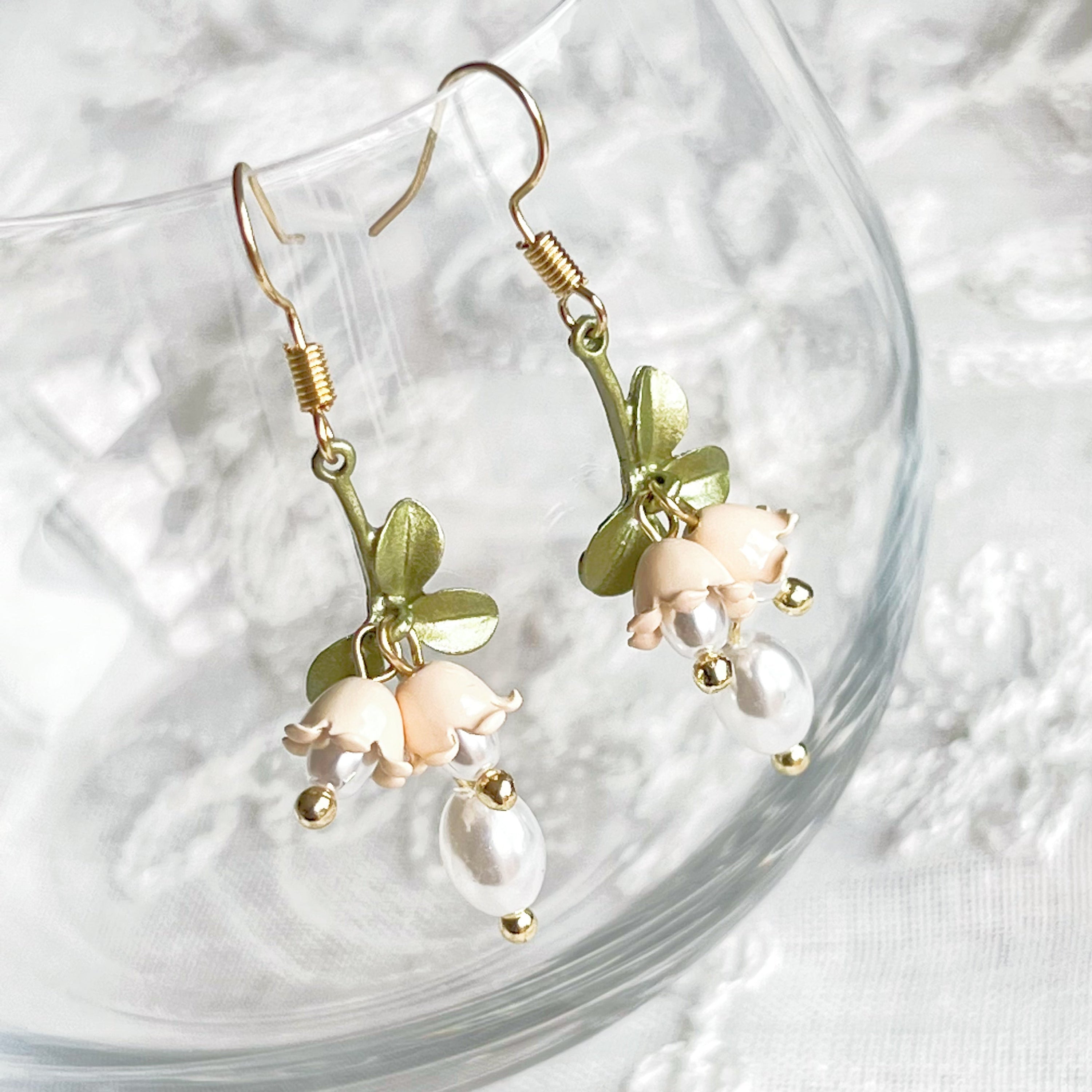 Elegant White Bellflower Little Drop Earrings with green leaves, symbolizing everlasting love, displayed in a gift box.