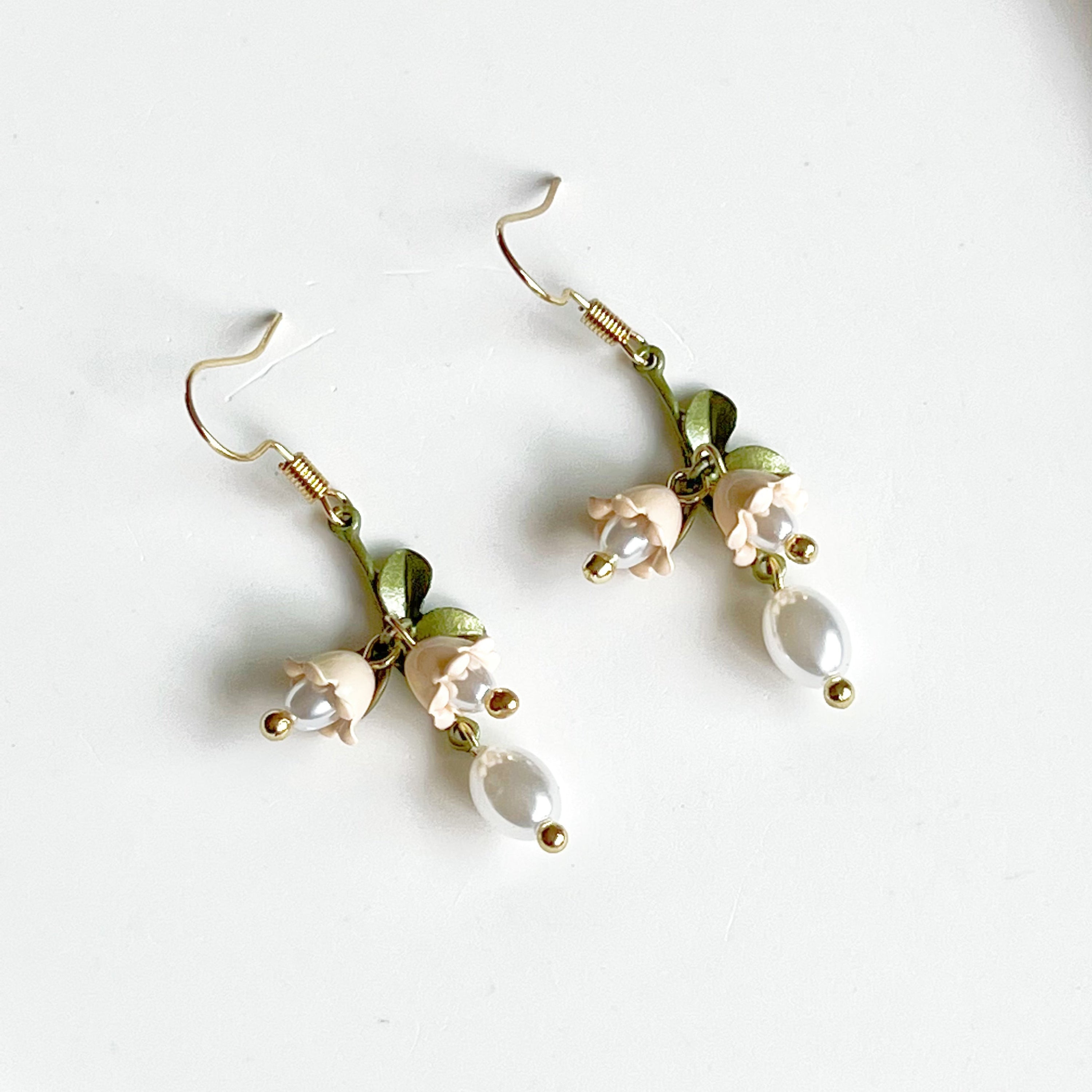 Elegant White Bellflower Little Drop Earrings with green leaves, symbolizing everlasting love, displayed in a gift box.