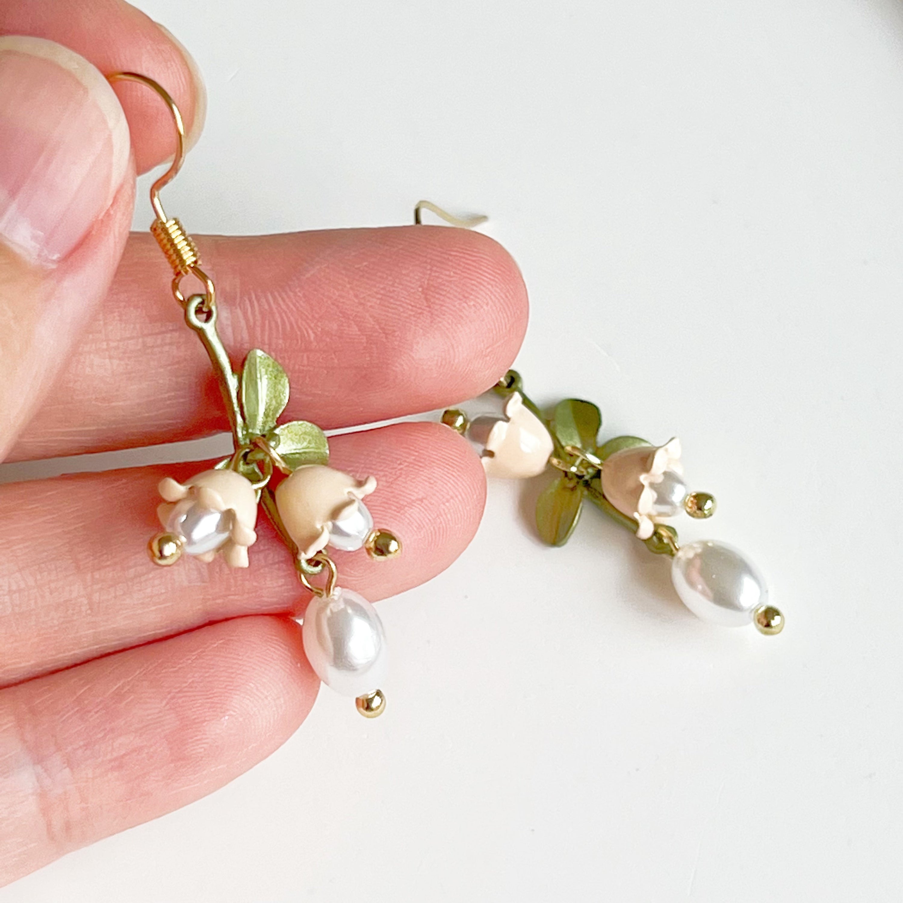 Elegant White Bellflower Little Drop Earrings with green leaves, symbolizing everlasting love, displayed in a gift box.