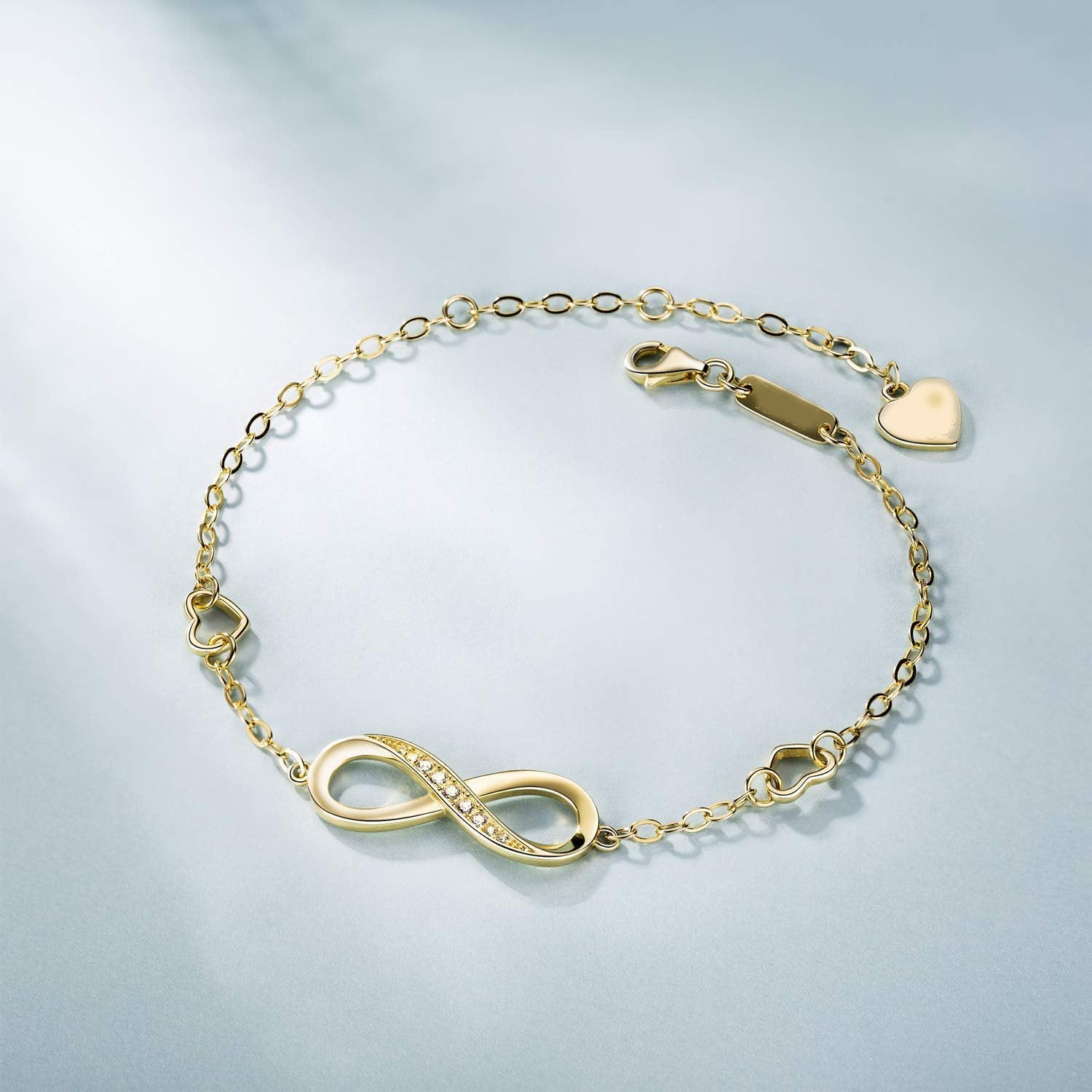 Elegant White Elements Infinite Pendant Chain Bracelet featuring 14K gold plating and a stunning infinity pendant with white elements.