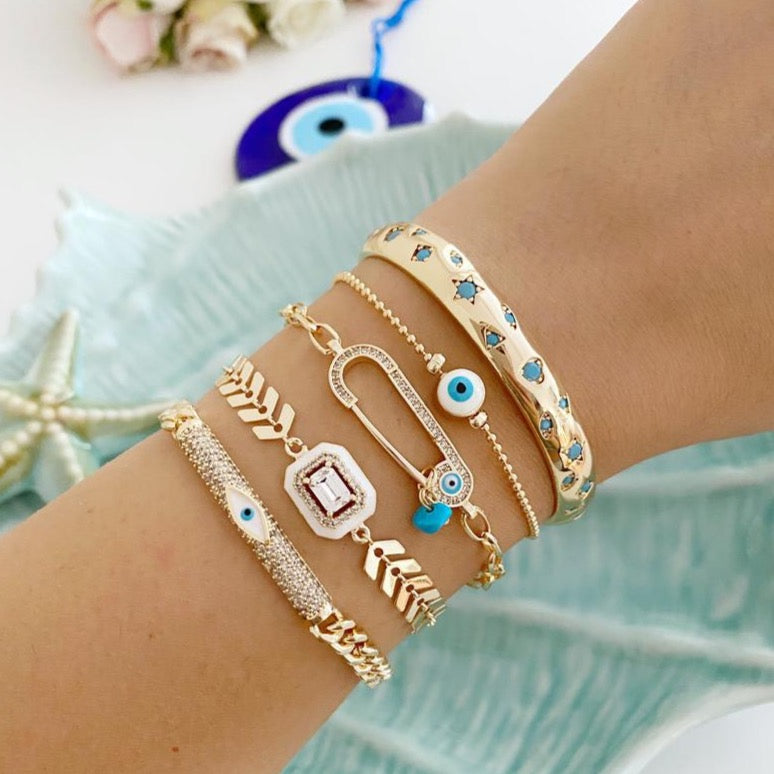 A beautiful White Evil Eye Bracelet featuring a gold bangle design, adjustable fit, and a protective evil eye charm.