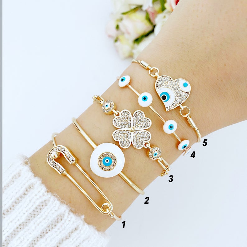 A stylish White Evil Eye Bracelet featuring a zircon charm, crafted from tarnish-resistant 316L stainless steel in a gold color.