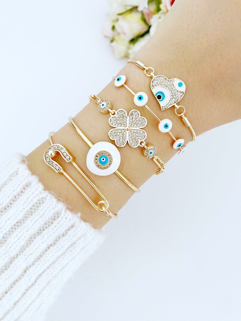 A stylish White Evil Eye Bracelet featuring a zircon charm, crafted from tarnish-resistant 316L stainless steel in a gold color.