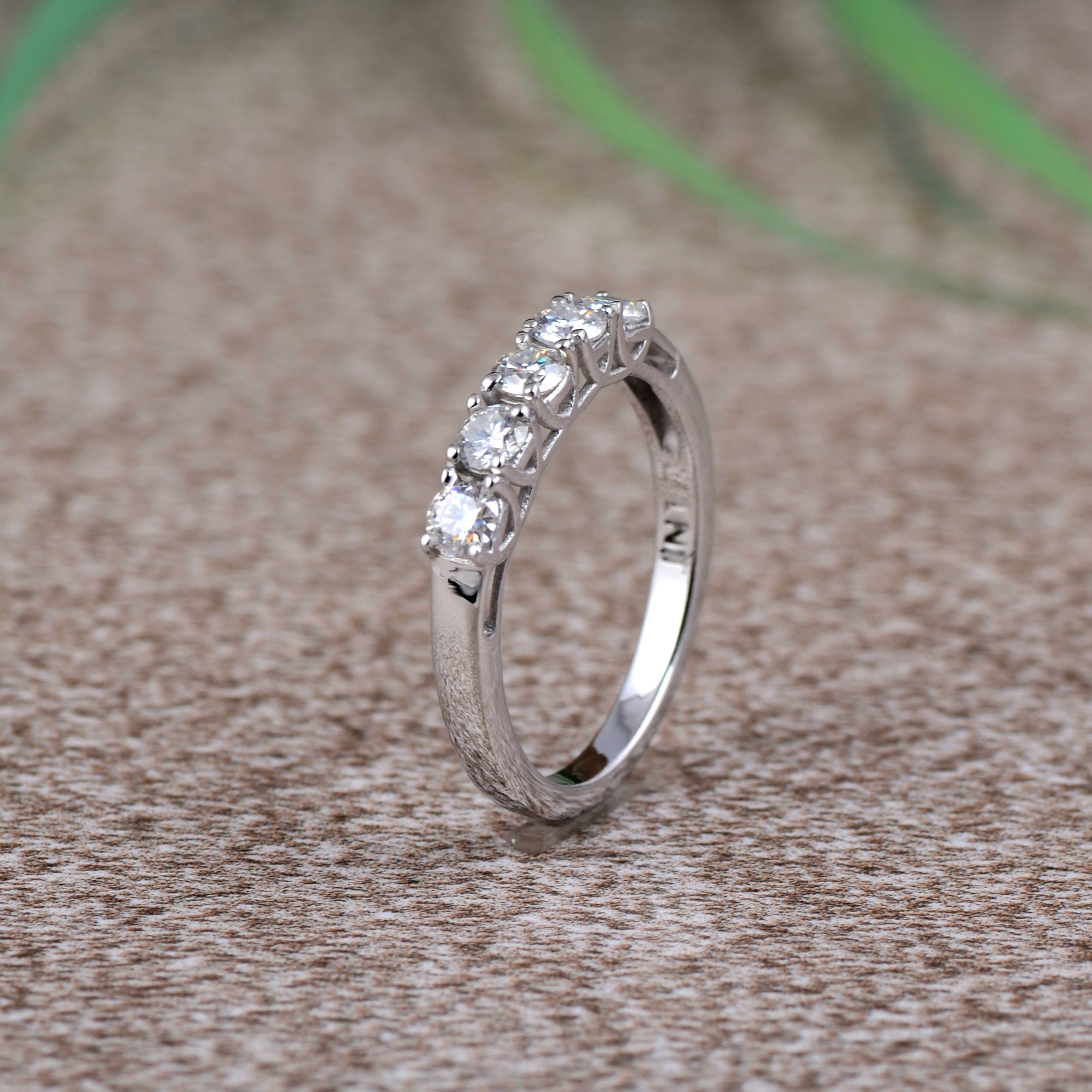 Elegant White Moissanite 5-Stone Ring set in high-polished sterling silver, featuring five round white stones.