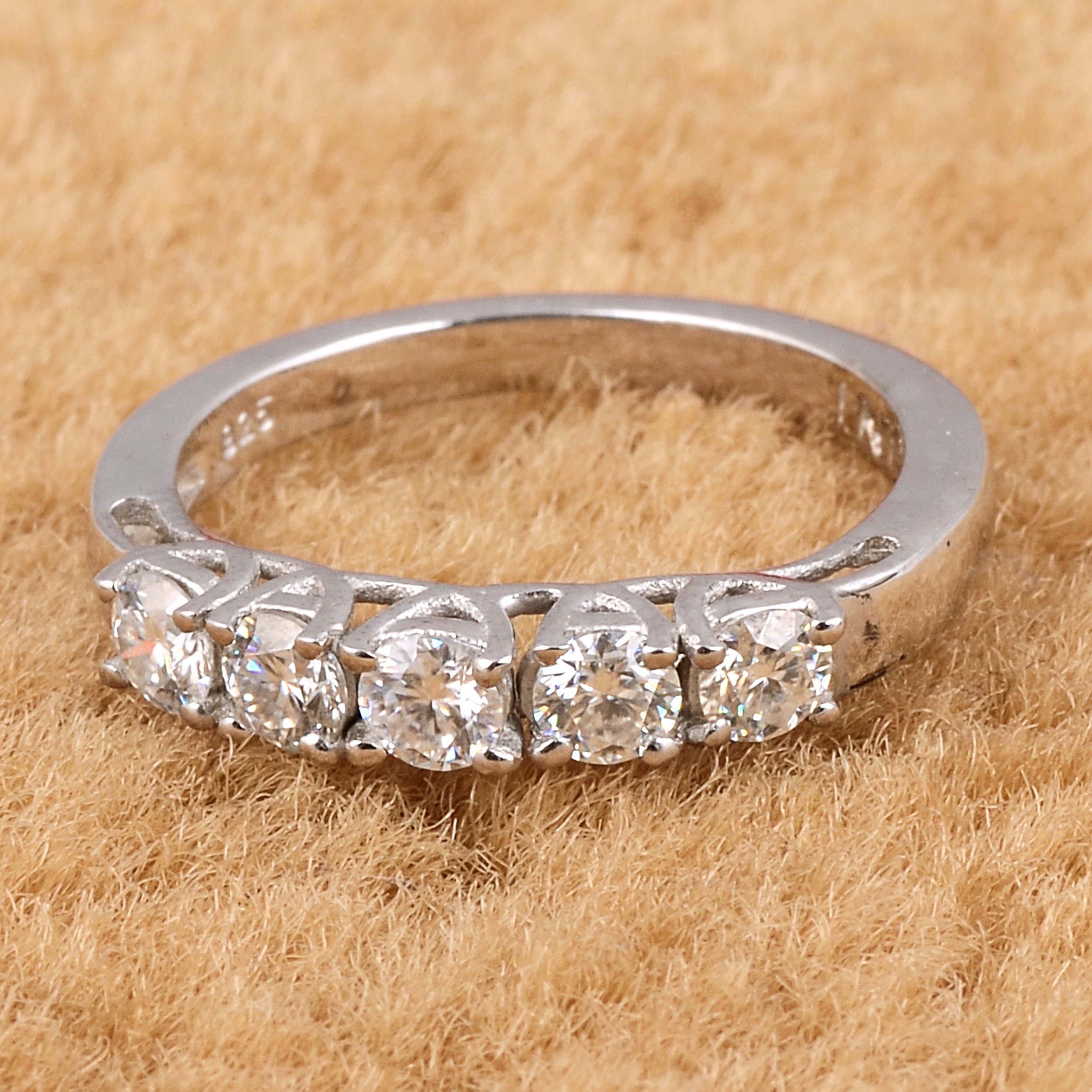 Elegant White Moissanite 5-Stone Ring set in high-polished sterling silver, featuring five round white stones.