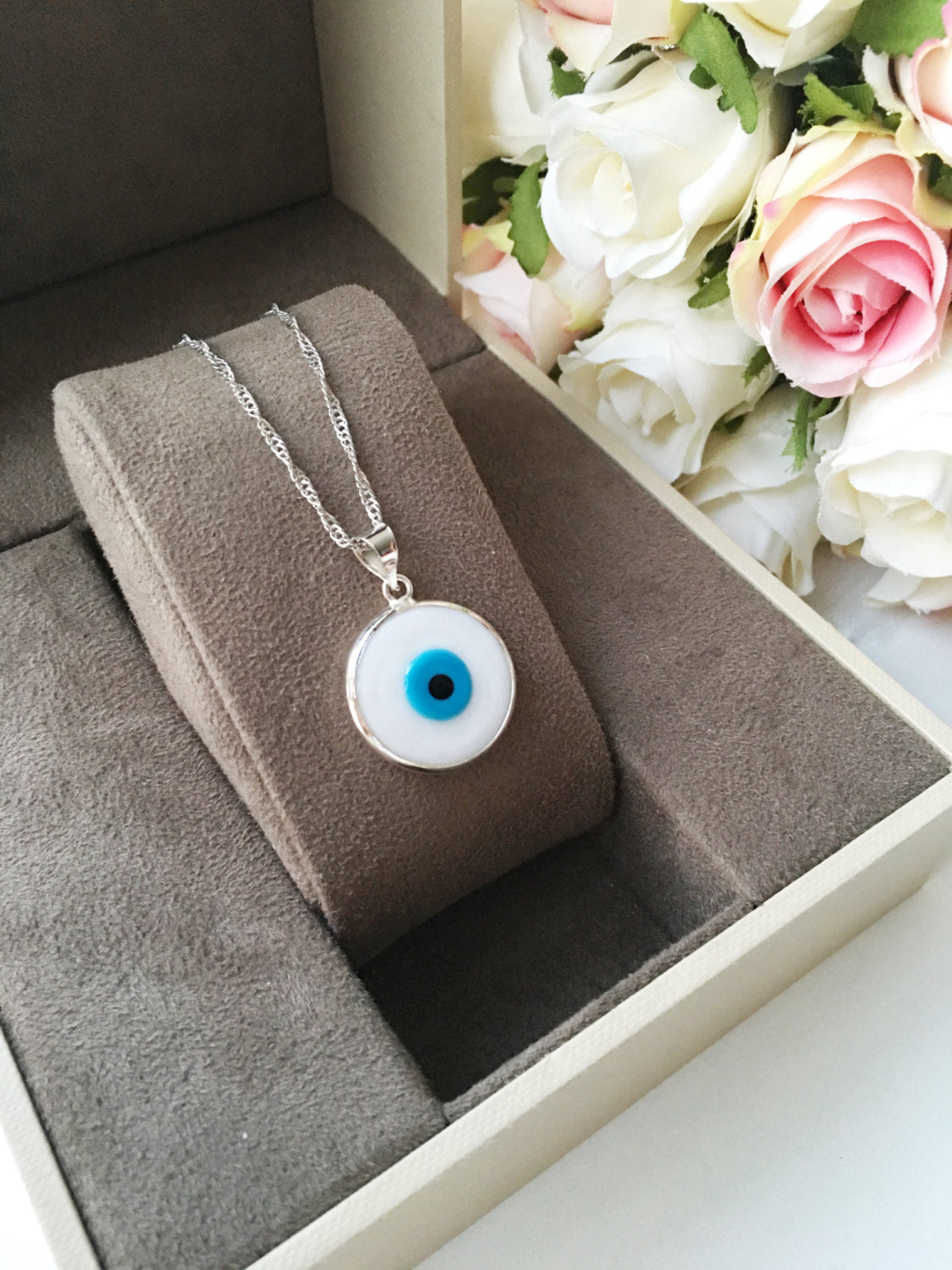 A beautiful White Murano Evil Eye Necklace featuring white glass beads and a silver plated chain, symbolizing protection and style.