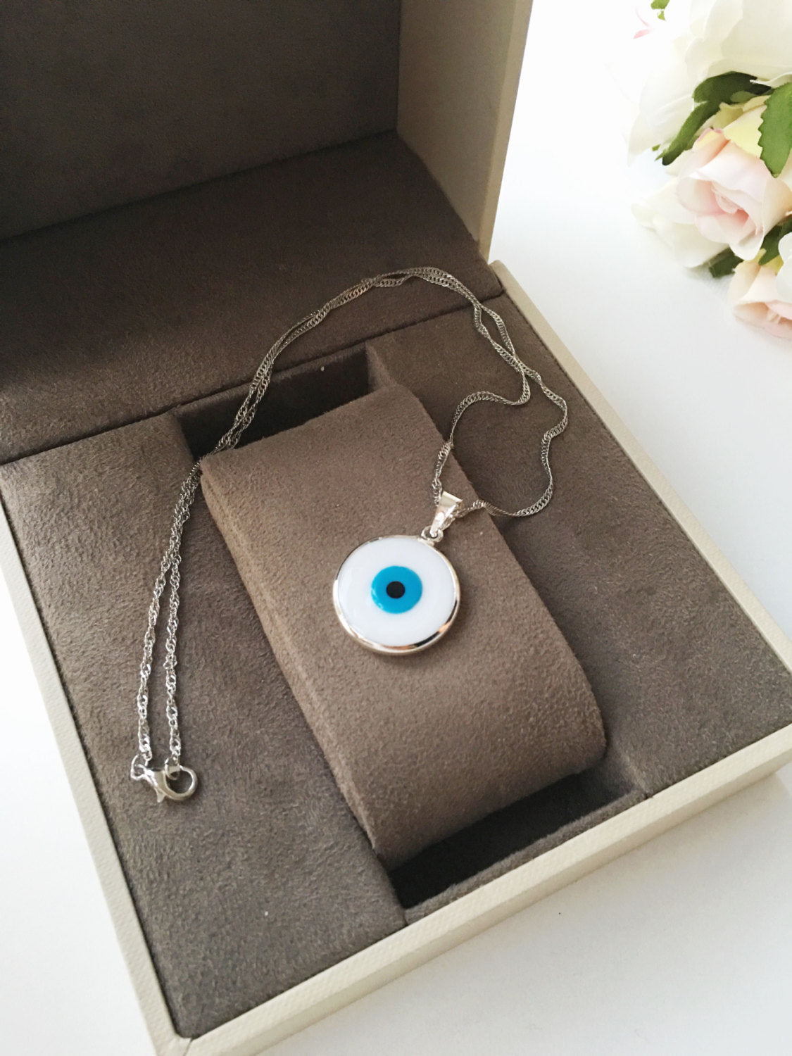 A beautiful White Murano Evil Eye Necklace featuring white glass beads and a silver plated chain, symbolizing protection and style.