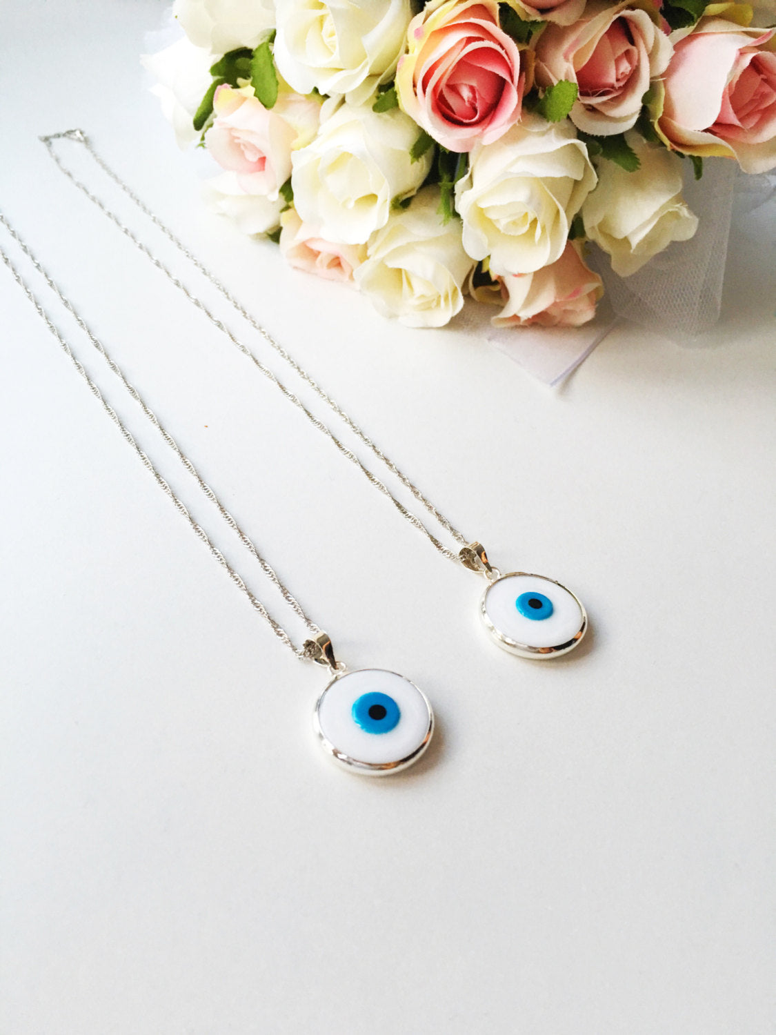 A beautiful White Murano Evil Eye Necklace featuring white glass beads and a silver plated chain, symbolizing protection and style.