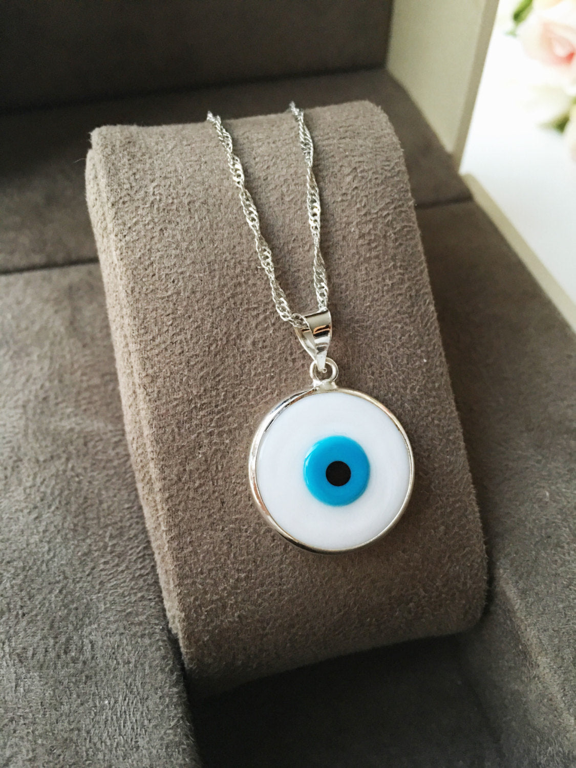 A beautiful White Murano Evil Eye Necklace featuring white glass beads and a silver plated chain, symbolizing protection and style.