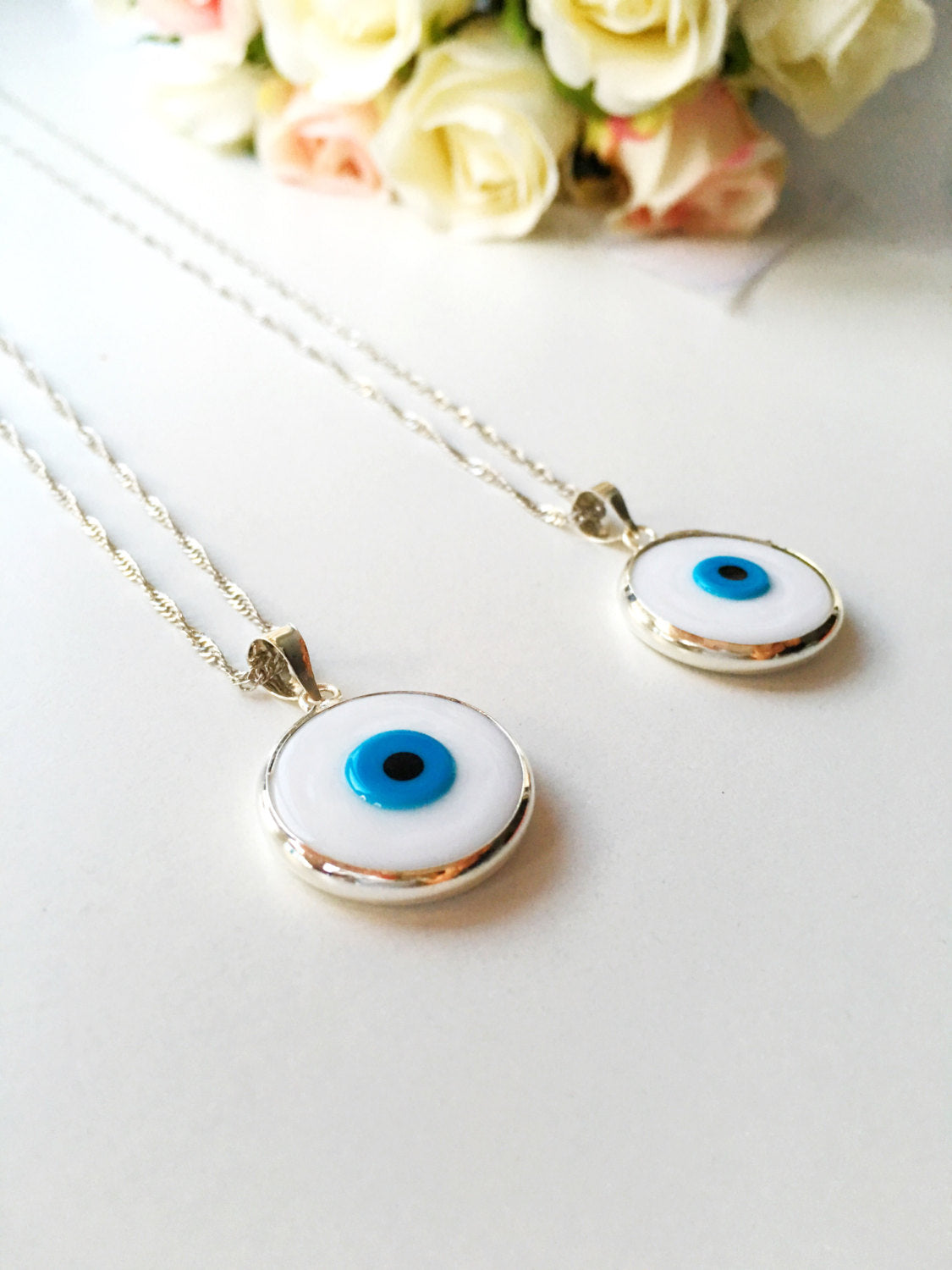 A beautiful White Murano Evil Eye Necklace featuring white glass beads and a silver plated chain, symbolizing protection and style.