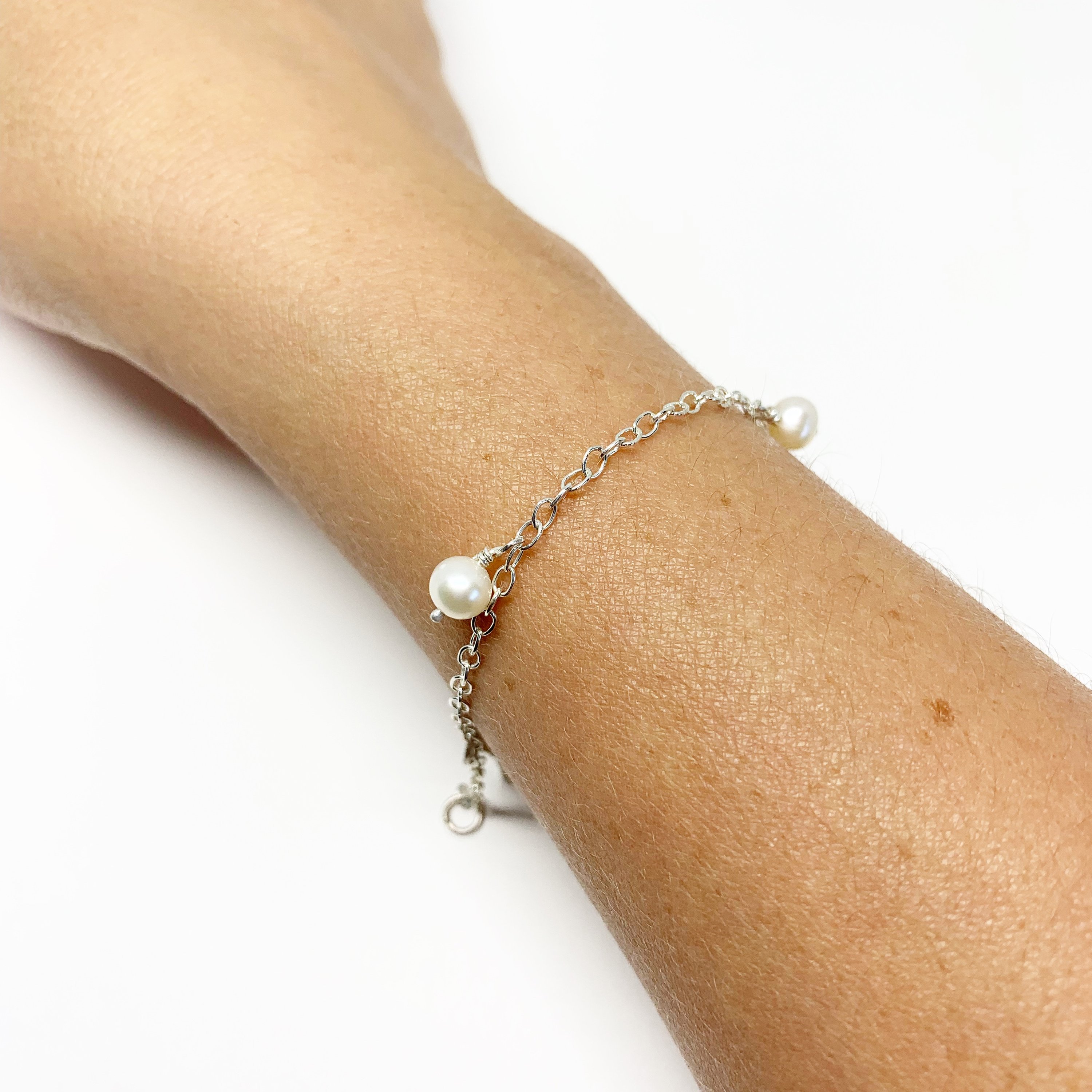 Elegant White Pearl Bracelet featuring five freshwater pearls on a delicate cable chain, perfect for any occasion.