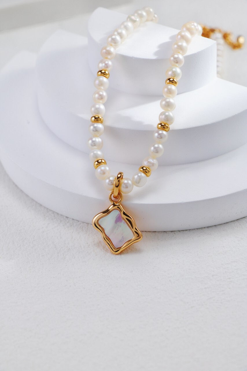 Elegant White Shell Double Sided Pendant Necklace with gold vermeil accents, showcasing its unique design and craftsmanship.