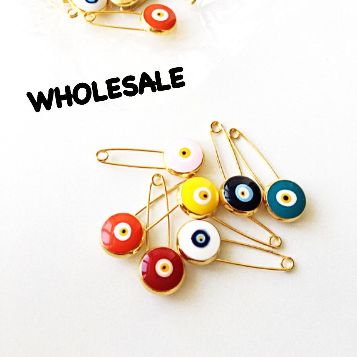 A collection of 50 gold plated lucky evil eye safety pins in various colors, designed for baby protection and gifting.