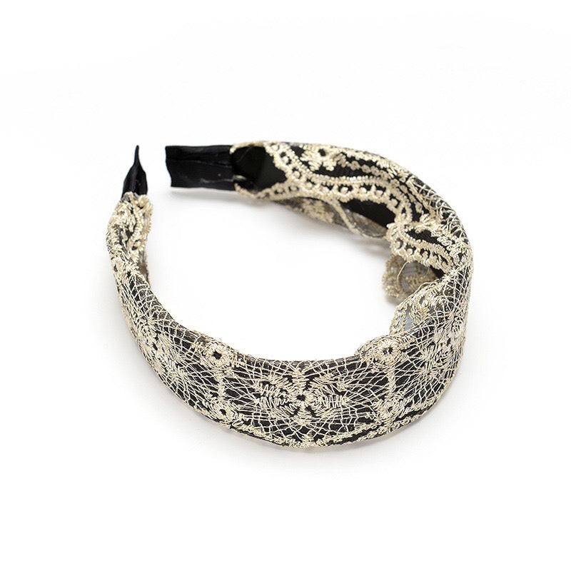 A collection of wide lace hair bands in various colors, showcasing their elegant design and lightweight fabric.