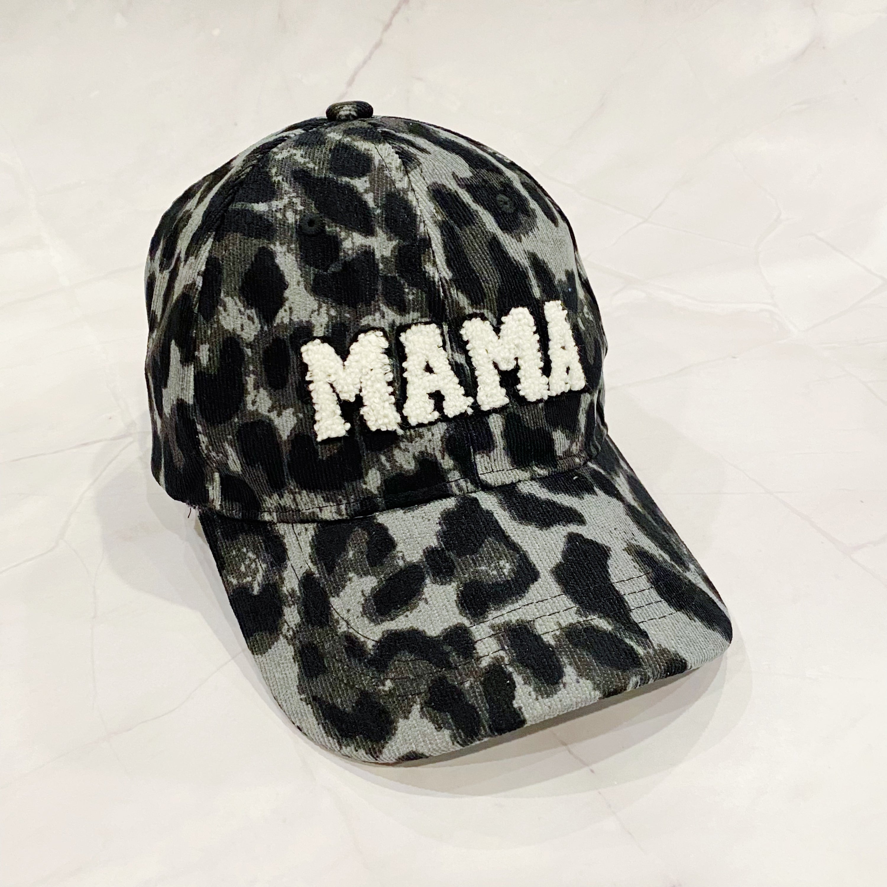 Wild Mama Corduroy Ball Cap featuring playful animal print and fuzzy lettering, adjustable strap, and hidden pocket for a sleek look.