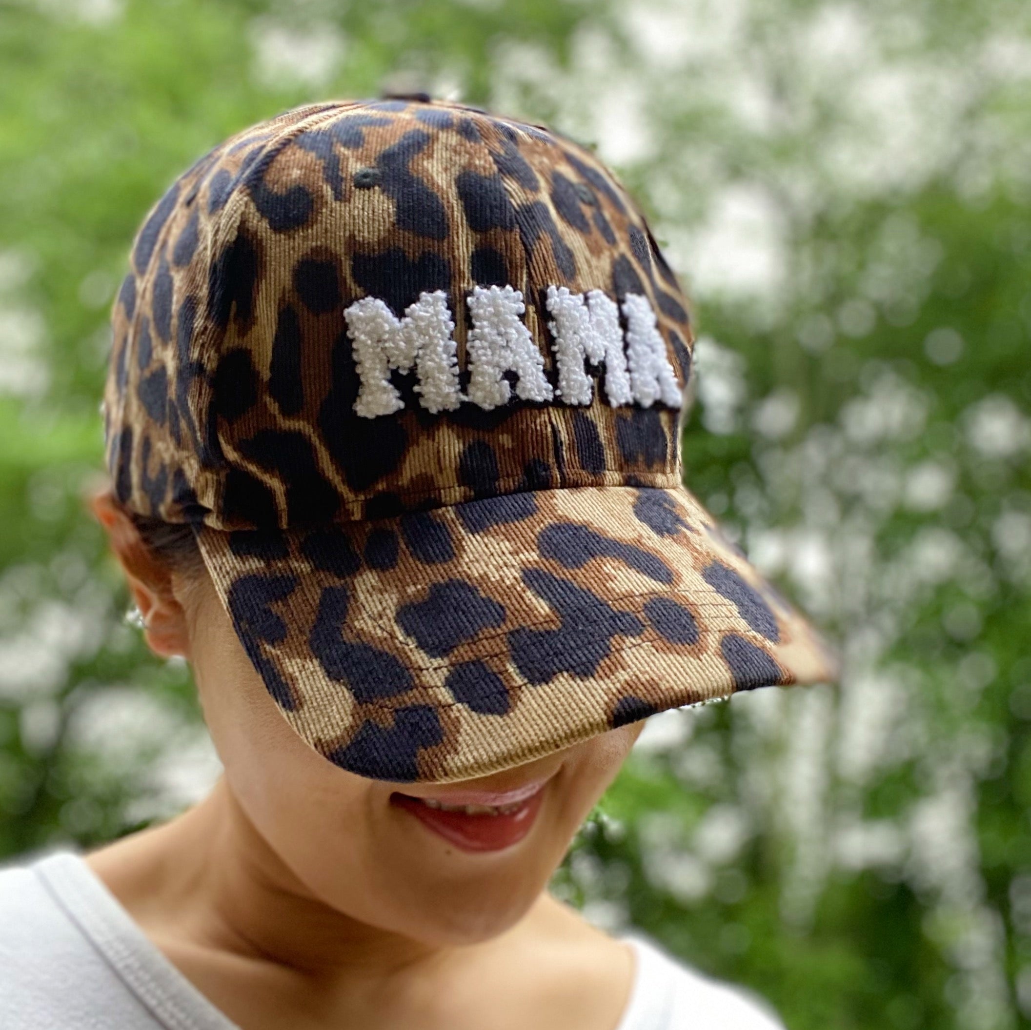 Wild Mama Corduroy Ball Cap featuring playful animal print and fuzzy lettering, adjustable strap, and hidden pocket for a sleek look.