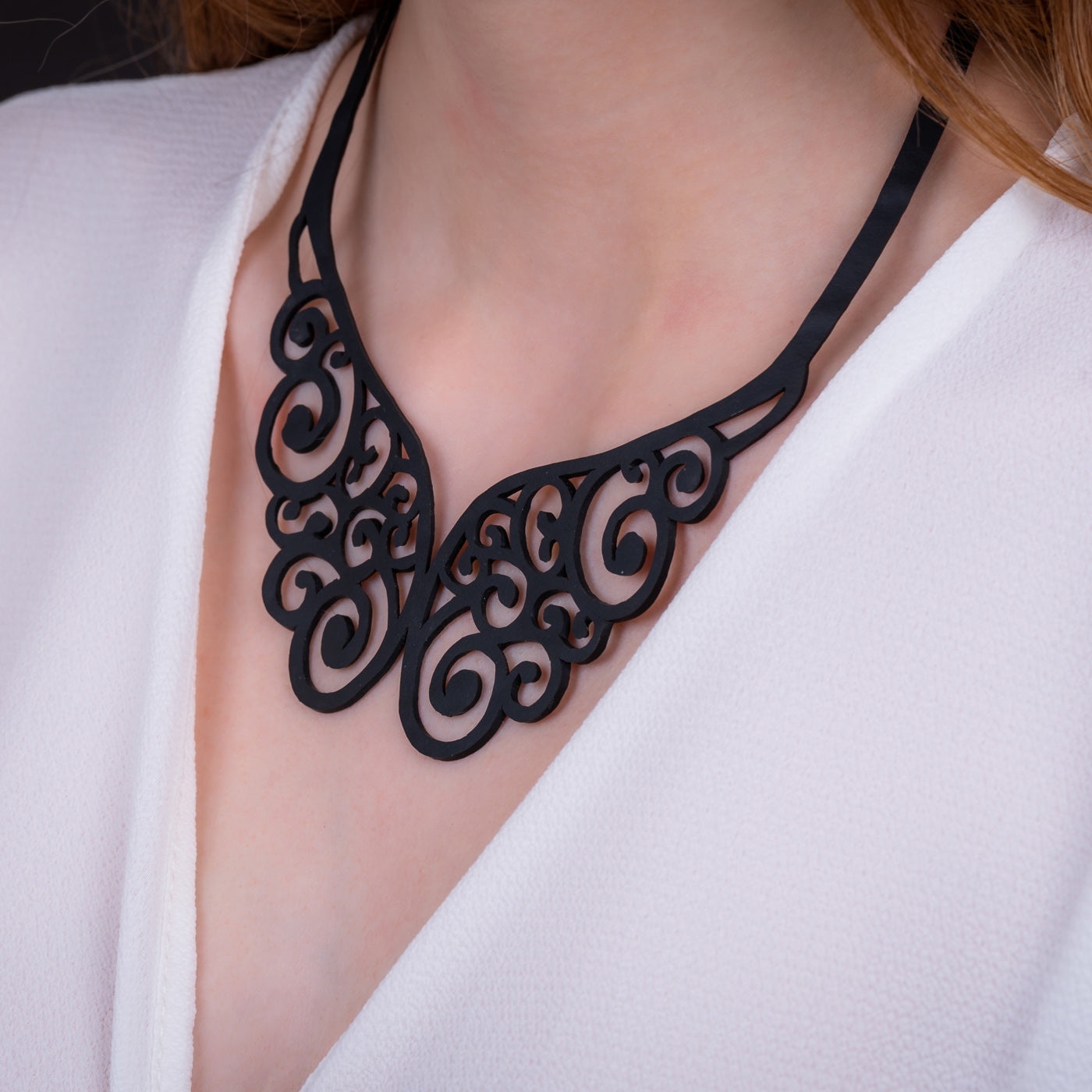 A beautifully handcrafted Wing Intricate Necklace made from upcycled inner tubes, featuring unique textures and patterns.