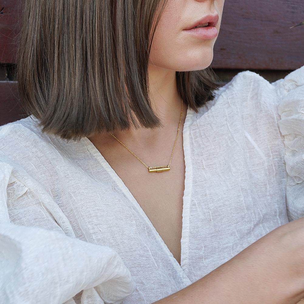 Wire Set featuring a mini bar necklace, tiny hoop earrings, and a cuff bangle in 14k gold over stainless steel, elegantly displayed in a gift box.