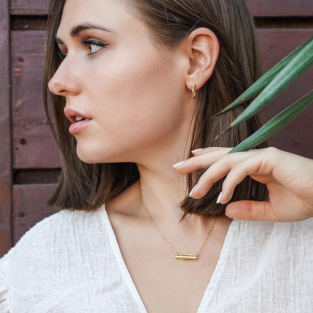 Wire Set featuring a mini bar necklace, tiny hoop earrings, and a cuff bangle in 14k gold over stainless steel, elegantly displayed in a gift box.