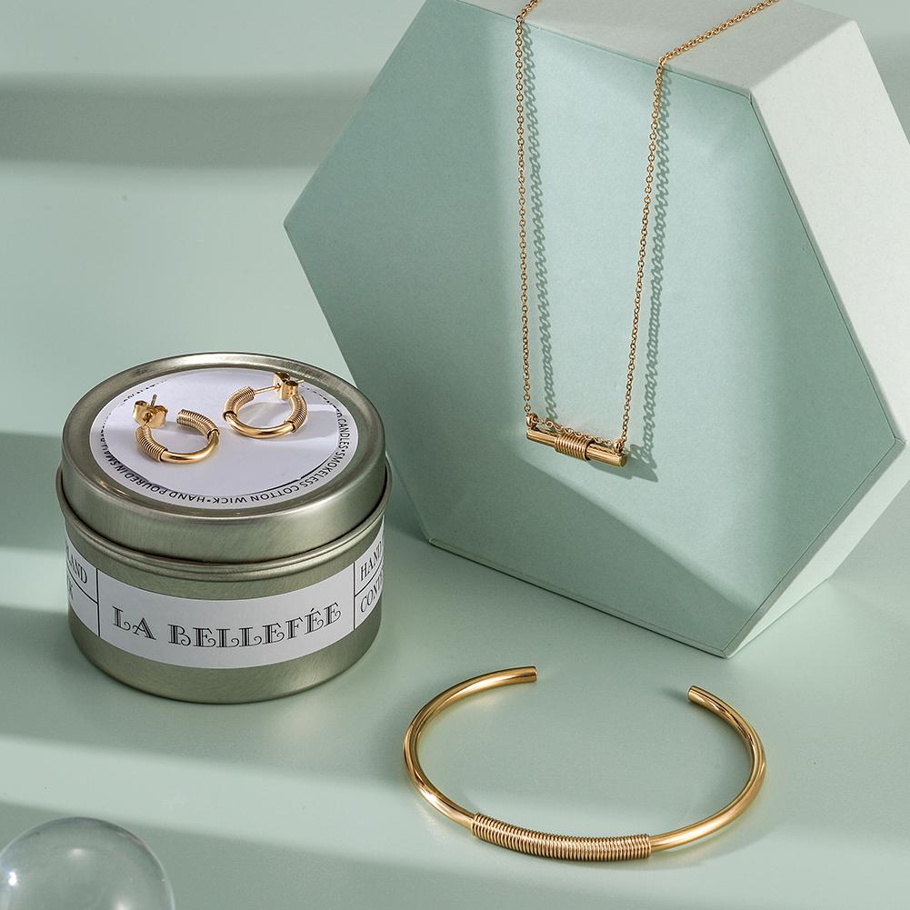 Wire Set featuring a mini bar necklace, tiny hoop earrings, and a cuff bangle in 14k gold over stainless steel, elegantly displayed in a gift box.