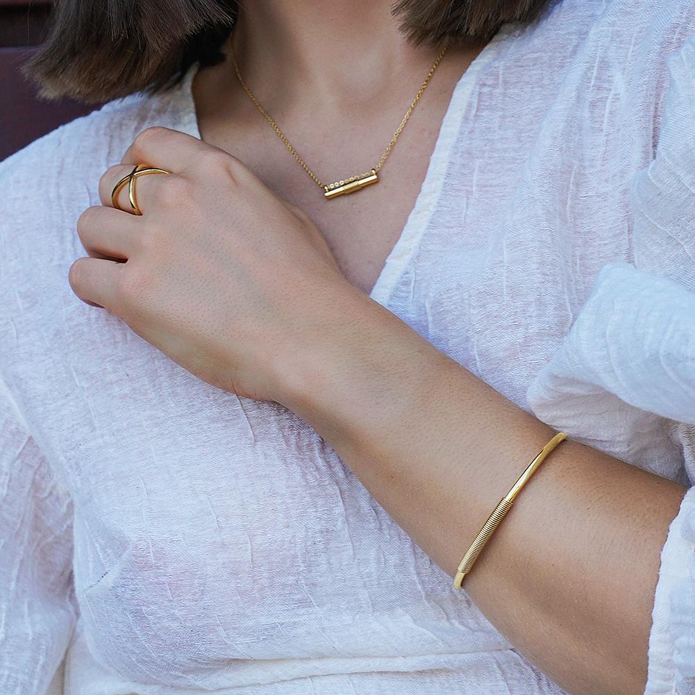 Wire Set featuring a mini bar necklace, tiny hoop earrings, and a cuff bangle in 14k gold over stainless steel, elegantly displayed in a gift box.