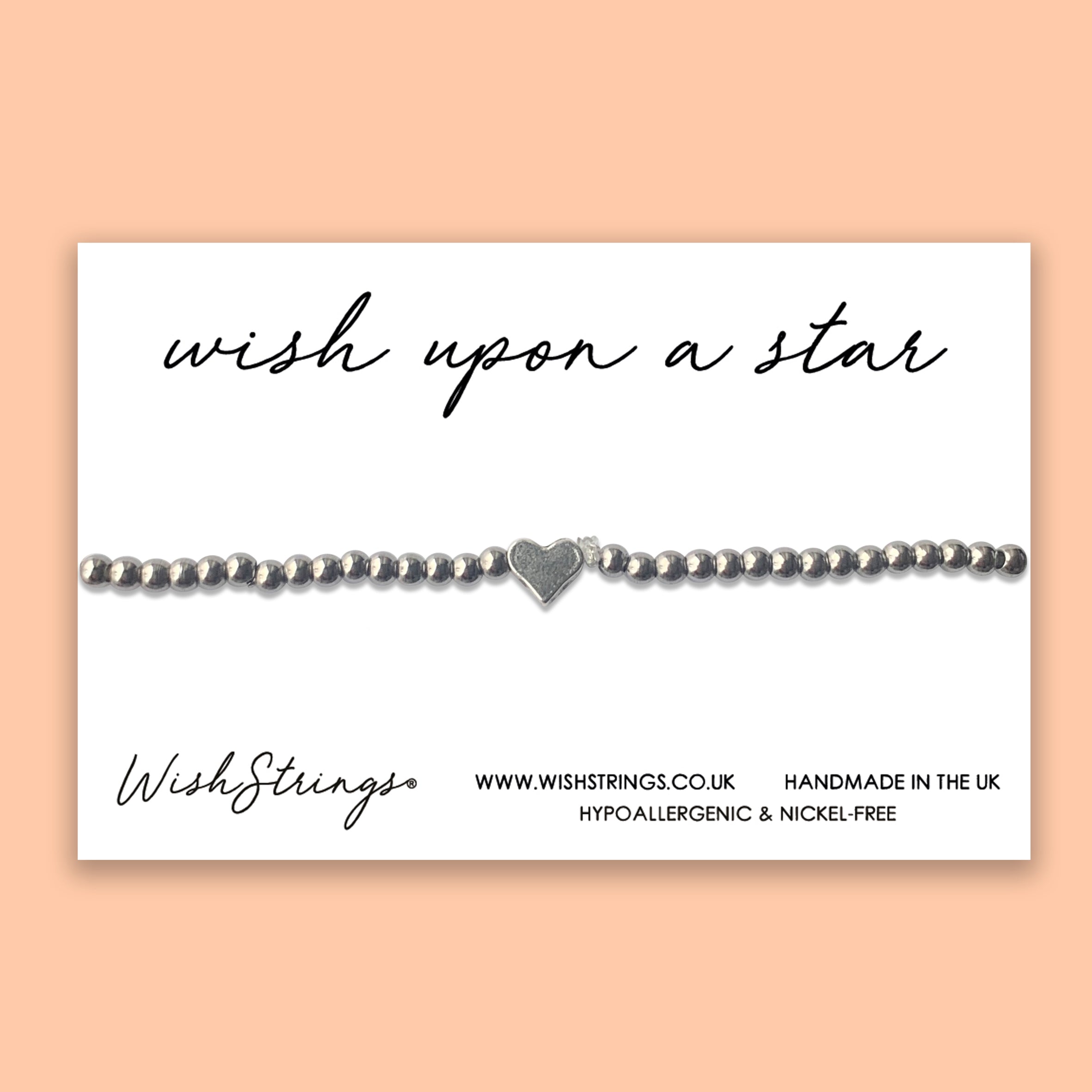 A beautiful handmade heart stretch bracelet from WishStrings, featuring elegant beads and a silver coating, perfect for gifting.