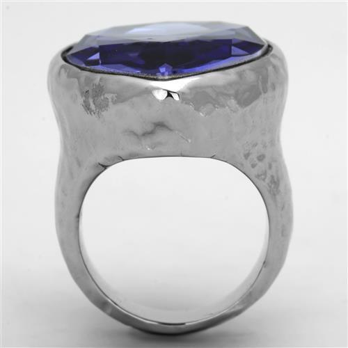 A stylish women's stainless steel ring featuring a high polished finish and a synthetic crystal tanzanite in a pear shape.