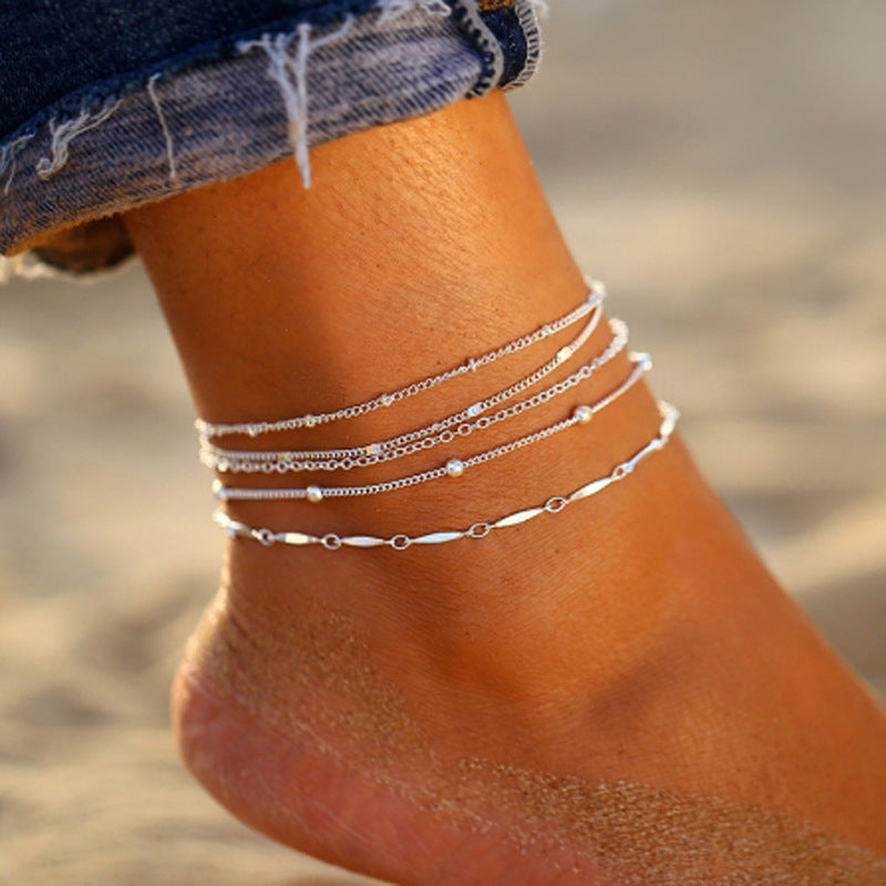 Elegant Women's Summer Anklet in 18K gold plating with gemstones, showcasing its adjustable design and luxurious shine.