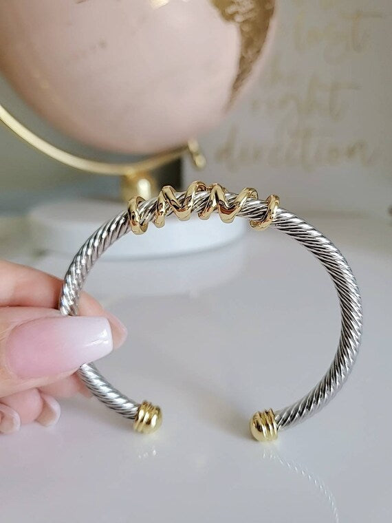 Elegant wrap around design cable bracelet with 18K gold filled accents, showcasing a unique pattern and durable stainless steel material.