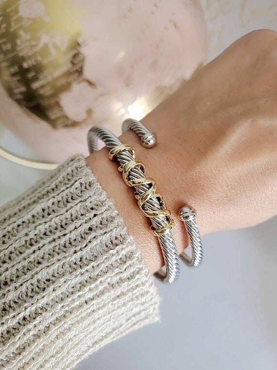 Elegant wrap around design cable bracelet with 18K gold filled accents, showcasing a unique pattern and durable stainless steel material.