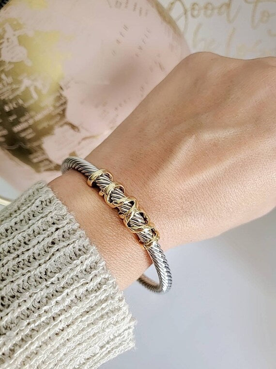 Elegant wrap around design cable bracelet with 18K gold filled accents, showcasing a unique pattern and durable stainless steel material.