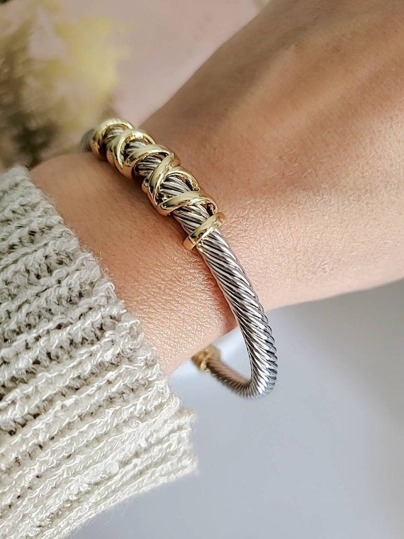 Elegant wrap around design cable bracelet with 18K gold filled accents, showcasing a unique pattern and durable stainless steel material.