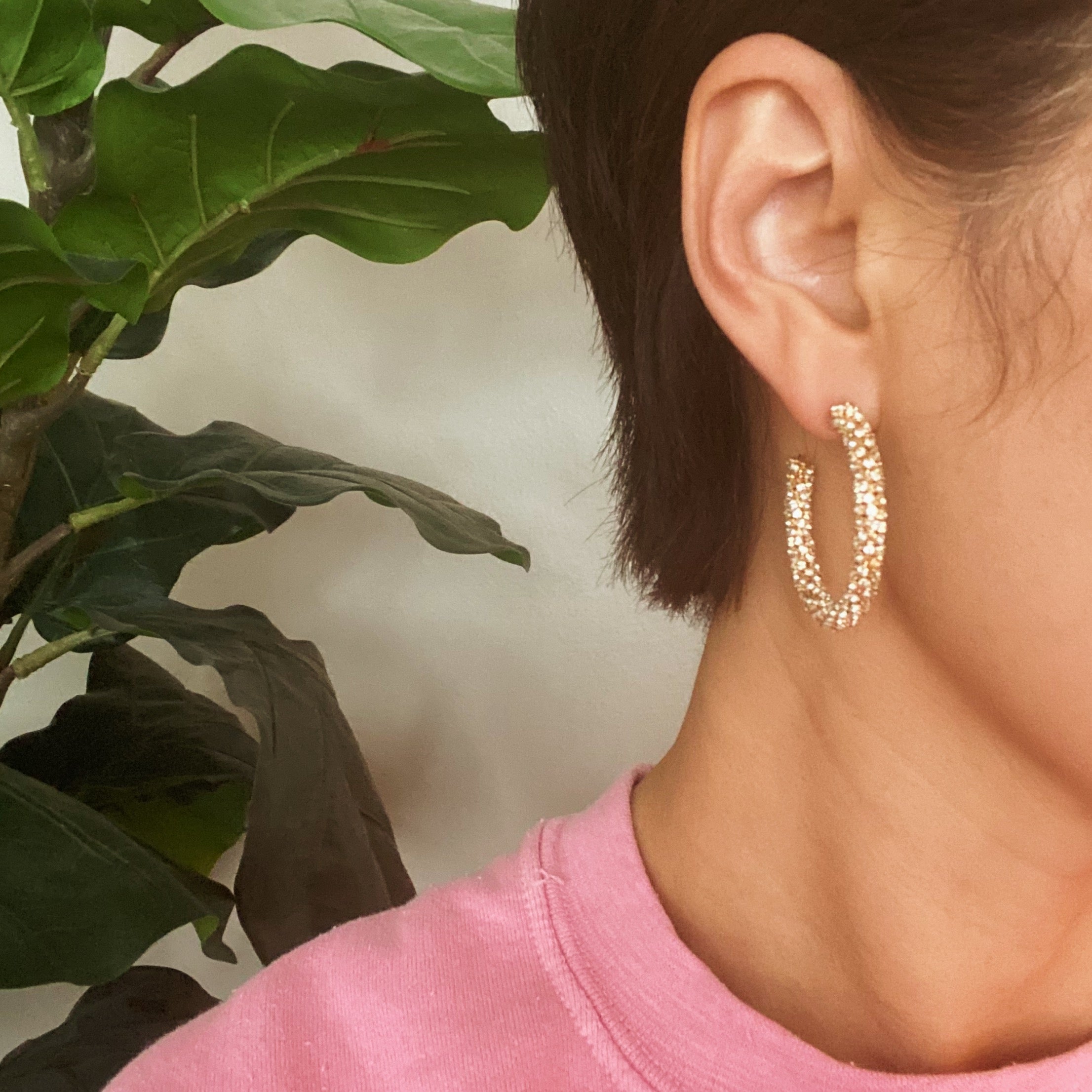 A pair of Wrapped In Shine Hoop Earrings featuring sparkling crystals on a classic hoop design, showcasing elegance and style.