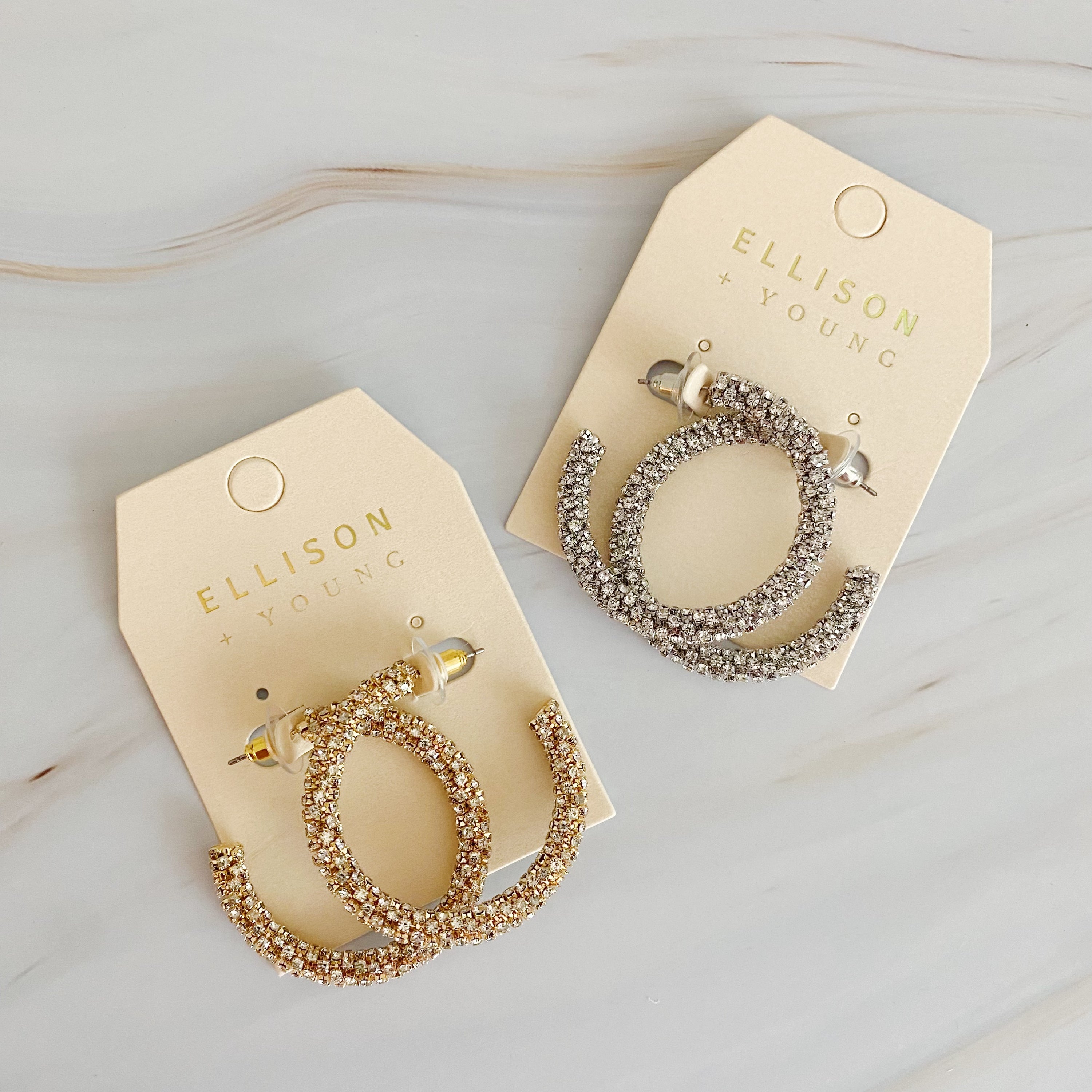 A pair of Wrapped In Shine Hoop Earrings featuring sparkling crystals on a classic hoop design, showcasing elegance and style.