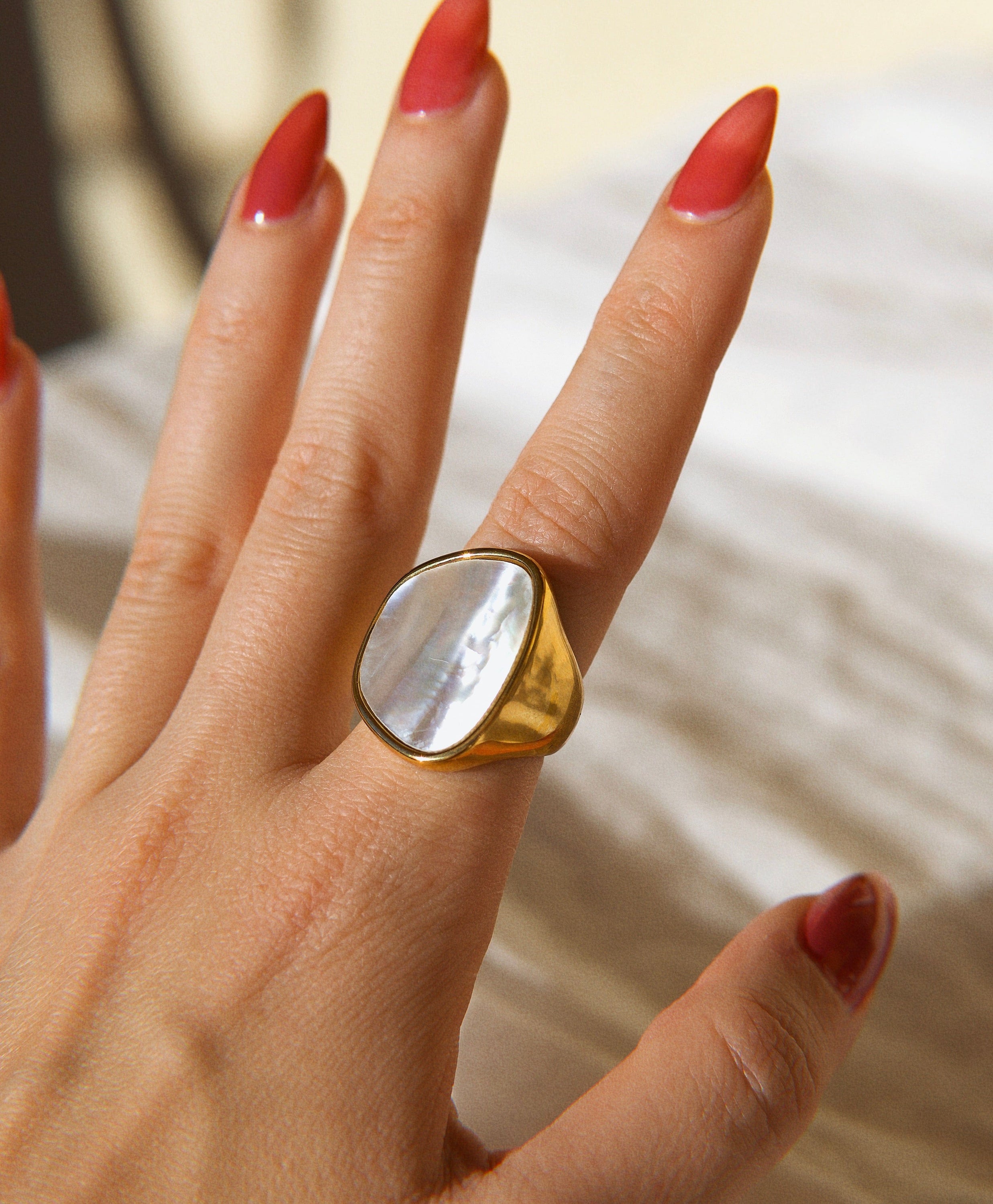 Xenia Large Antique Mother of Pearl Ring featuring a bold geometric design with an 18K gold plated stainless steel band and natural white shell stone.