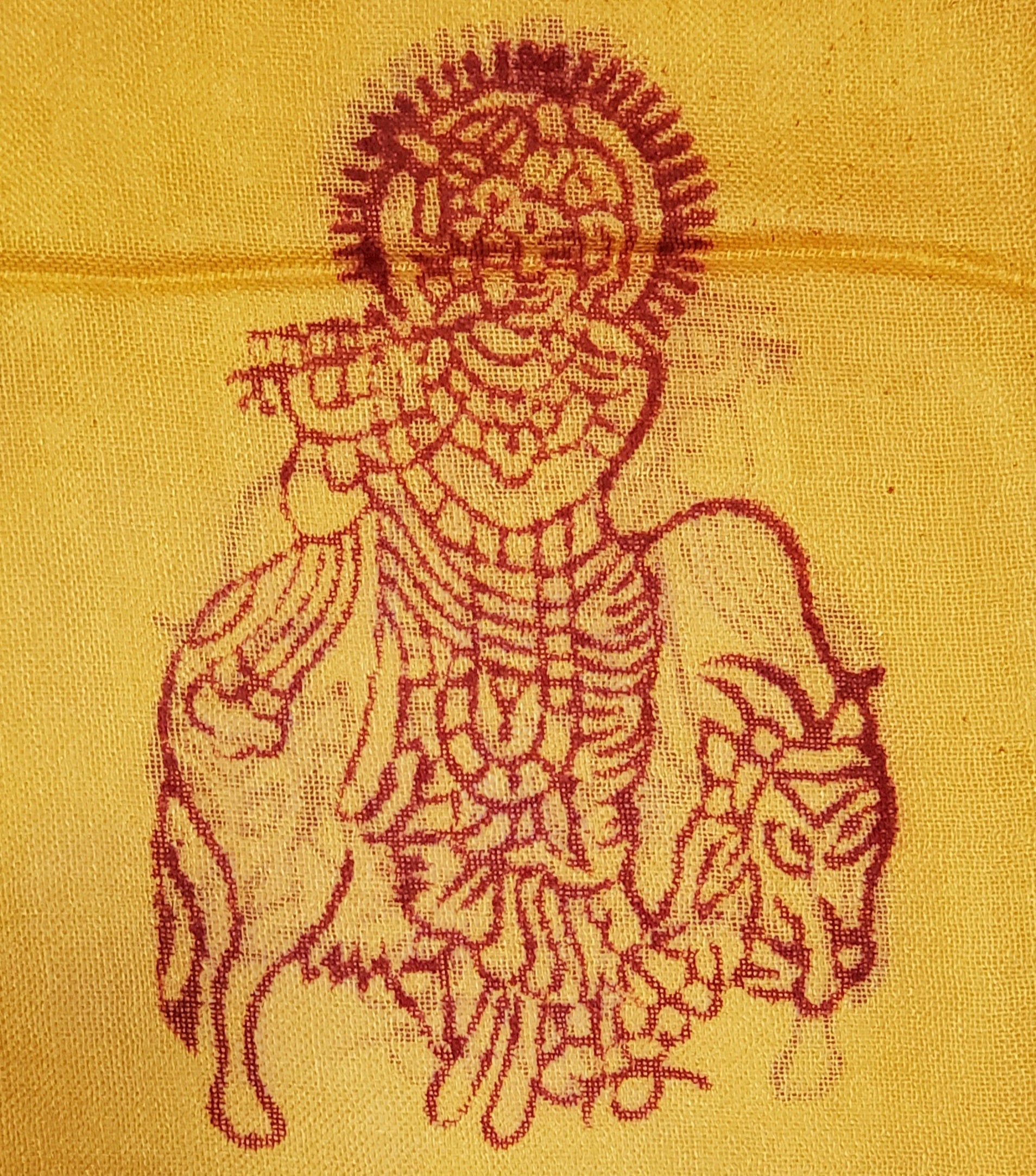 A vibrant yellow scarf featuring spiritual symbols including Om, Ganesha, tridents, and henna patterns, perfect for stylish wear.