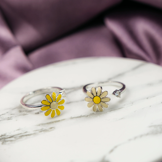 A beautiful yellow rotating sunflower ring with dainty floral design, showcasing its intricate craftsmanship and adjustable fit.