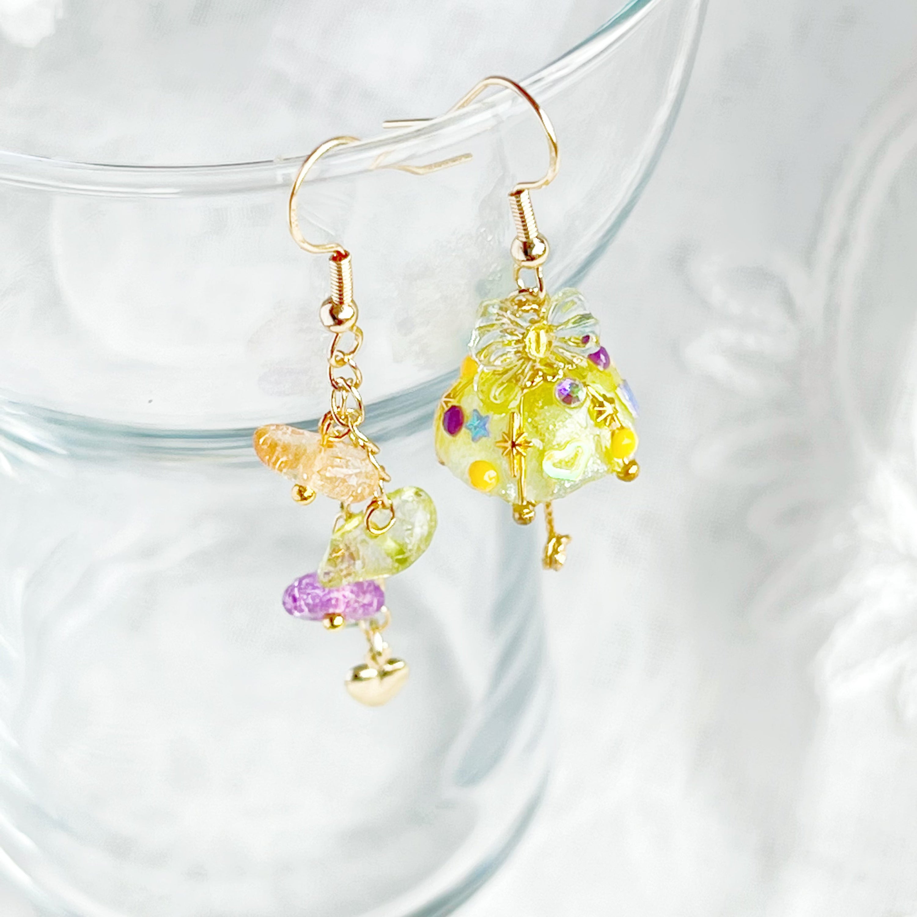 A pair of handmade yellow umbrella drop earrings adorned with colorful rainbow stones, showcasing a unique mismatch design.