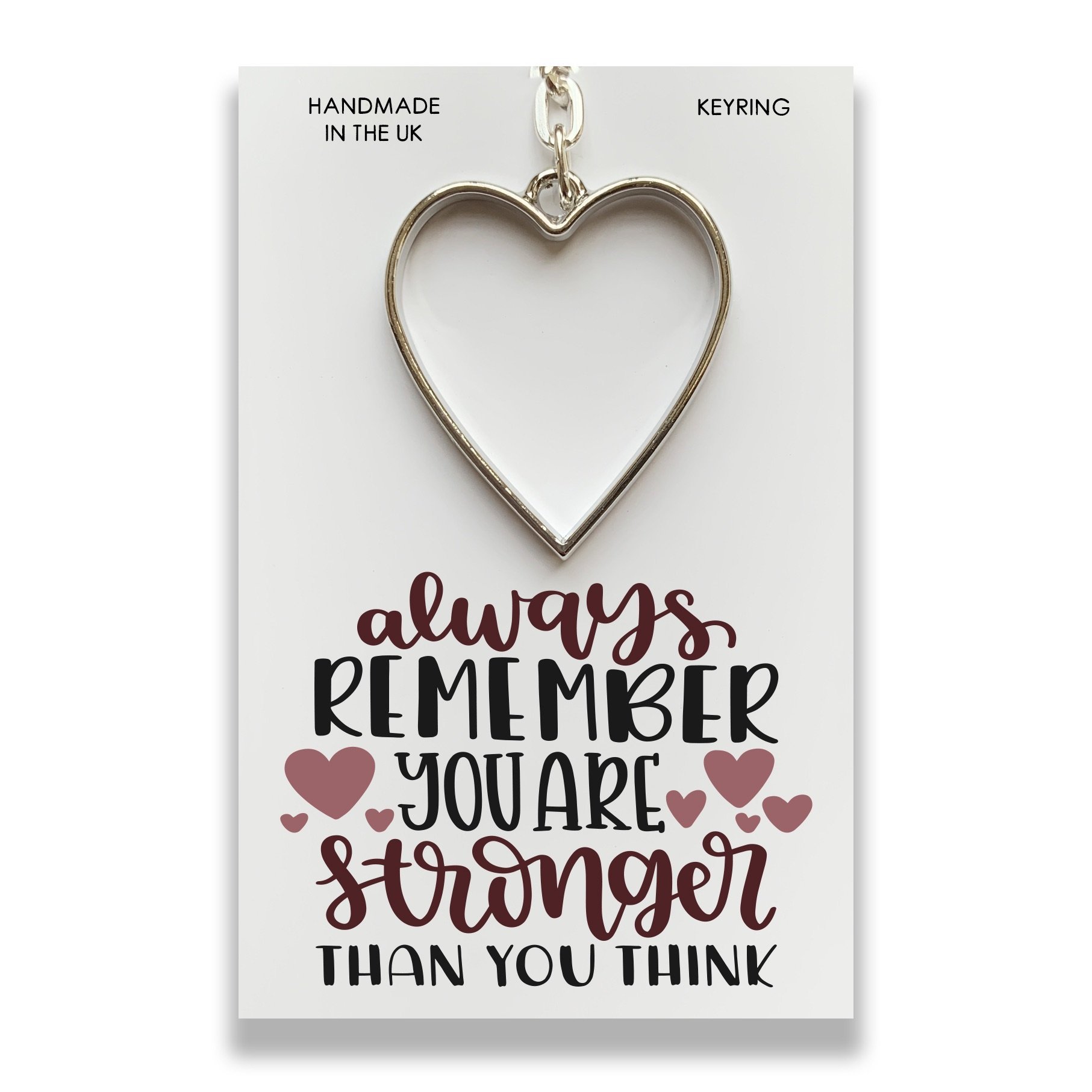 Handmade 'You are Stronger' keyring on a presentation card, featuring an inspirational message.