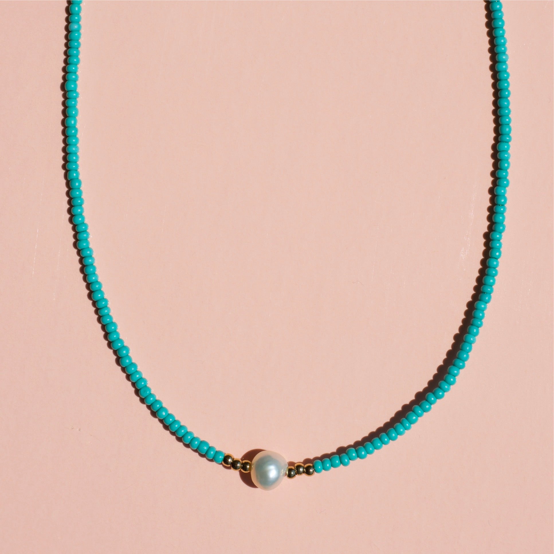 Zagros Beaded Pearl Choker Necklace featuring natural pearls and colored beads on a gold chain.