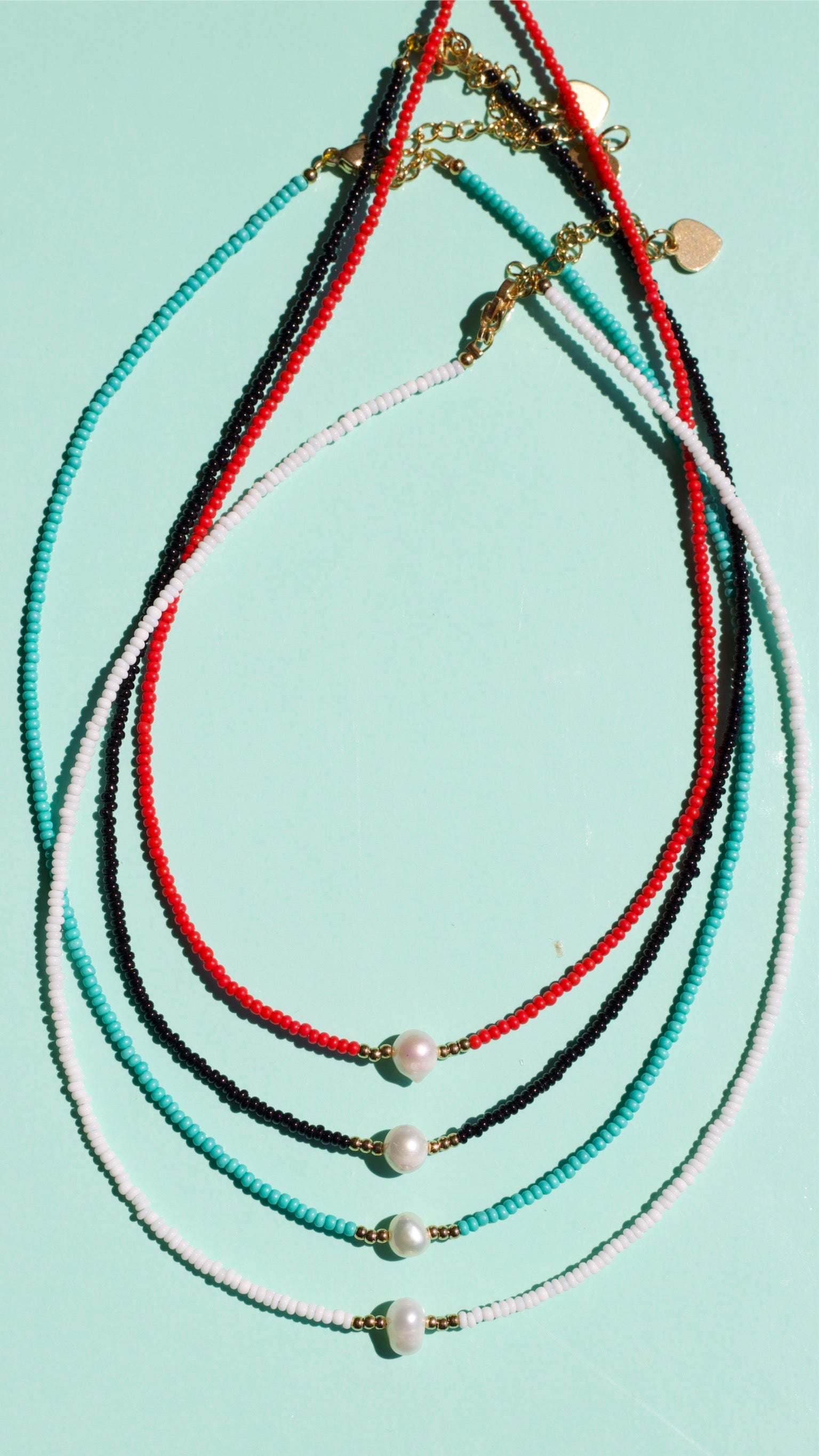 Zagros Beaded Pearl Choker Necklace featuring natural pearls and colored beads on a gold chain.