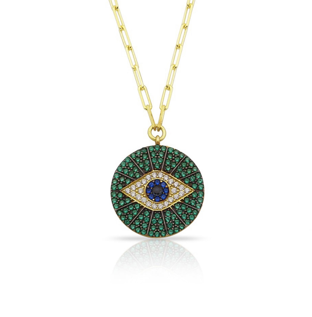 ZIBA Necklace featuring a medallion evil eye pendant with emerald green, royal blue, and bright white cubic zirconias on a 925 sterling silver chain.