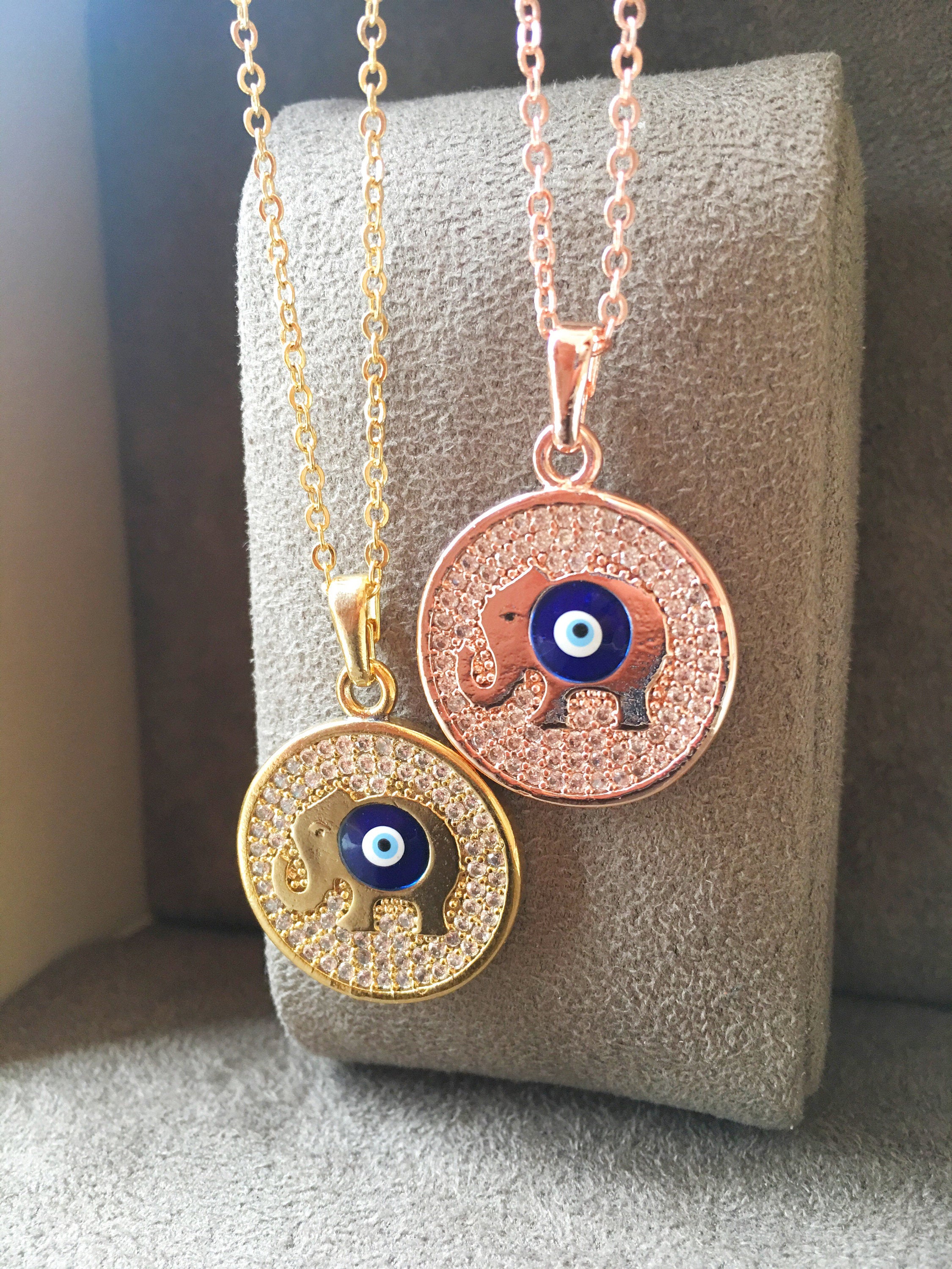 Zircon Evil Eye Necklace featuring an elephant charm on a rose gold chain, symbolizing protection and good luck.