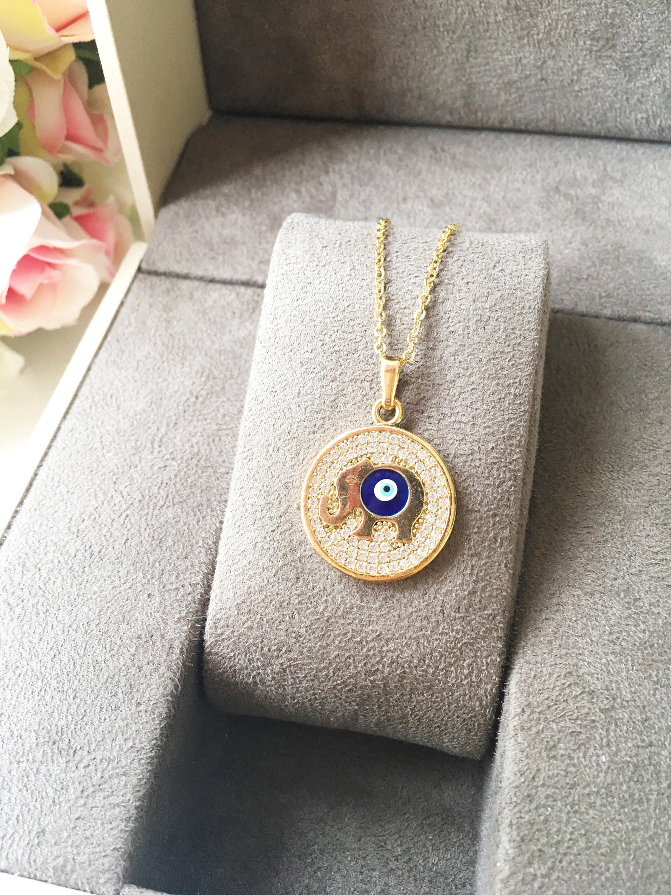 Zircon Evil Eye Necklace featuring an elephant charm on a rose gold chain, symbolizing protection and good luck.