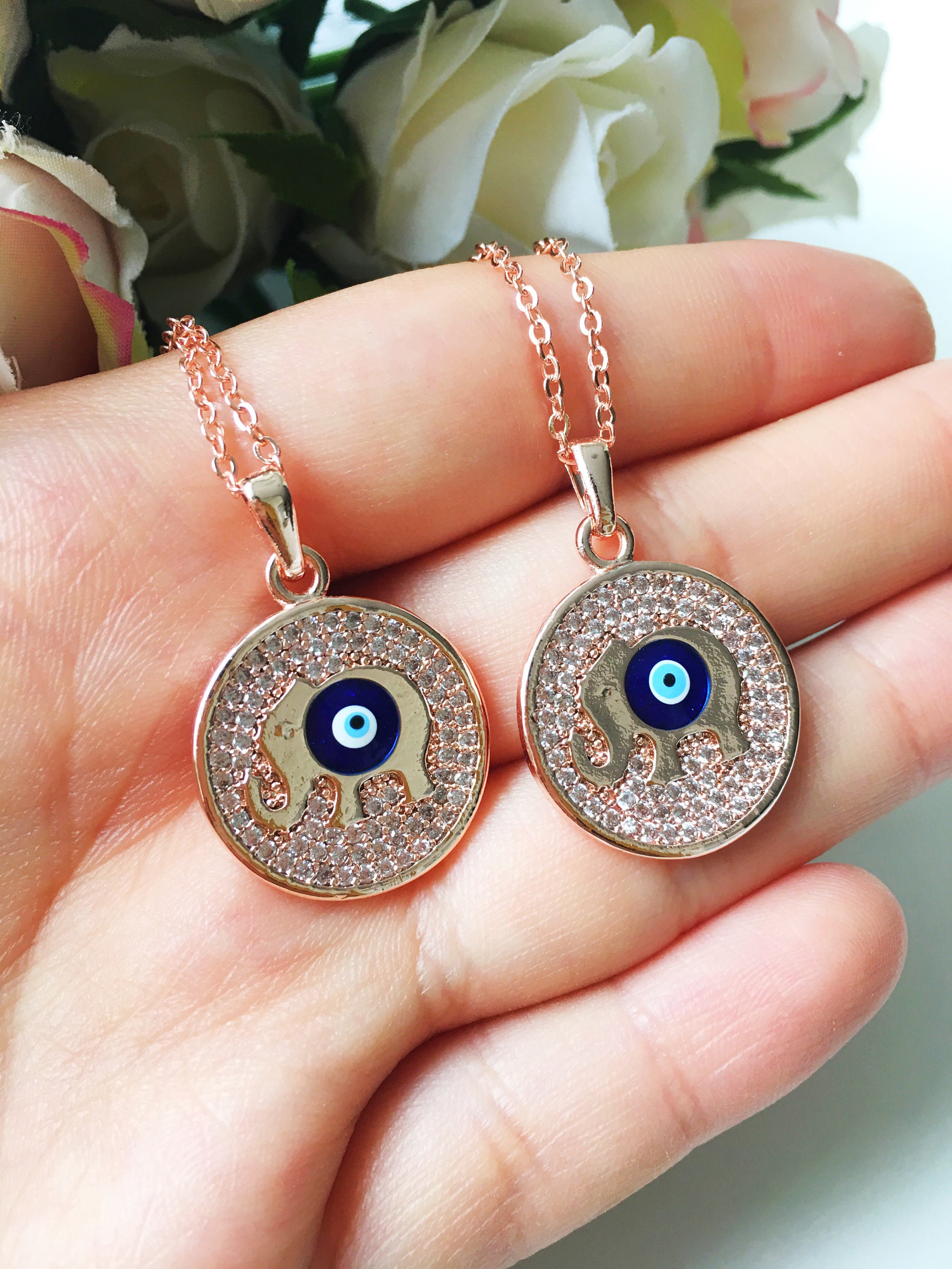 Zircon Evil Eye Necklace featuring an elephant charm on a rose gold chain, symbolizing protection and good luck.